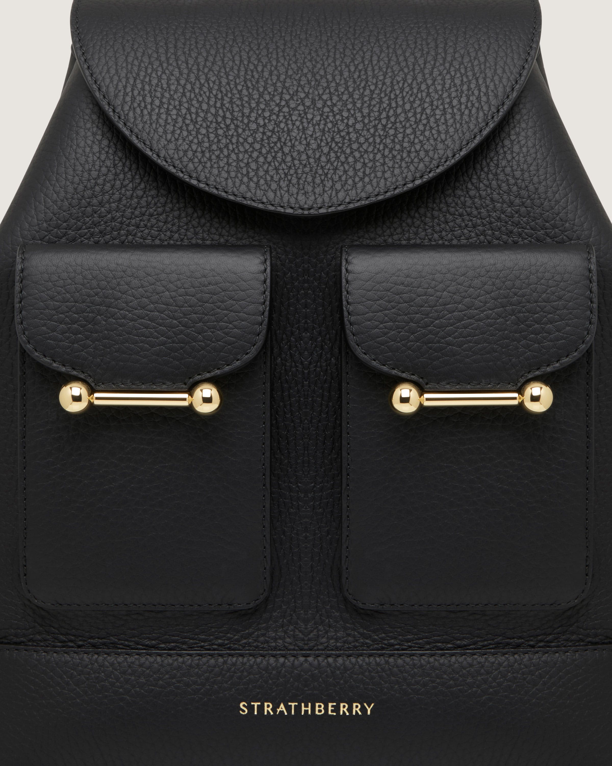 A black leather backpack with gold hardwares