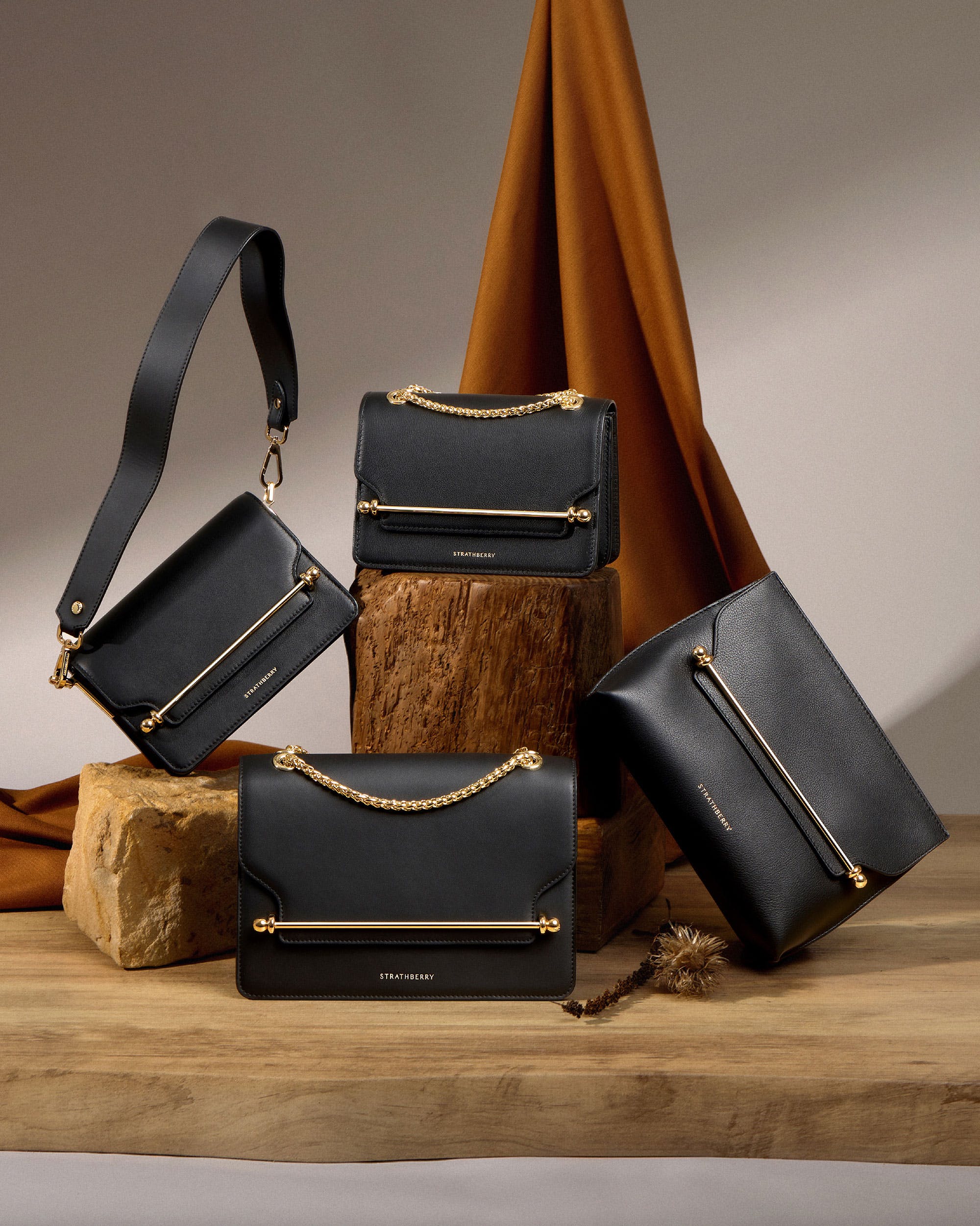 A group of black bags sitting on top of a wooden table