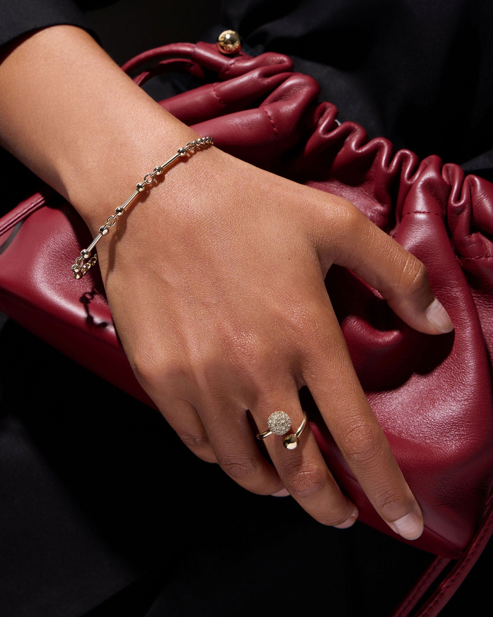 A woman's hand holding a red purse