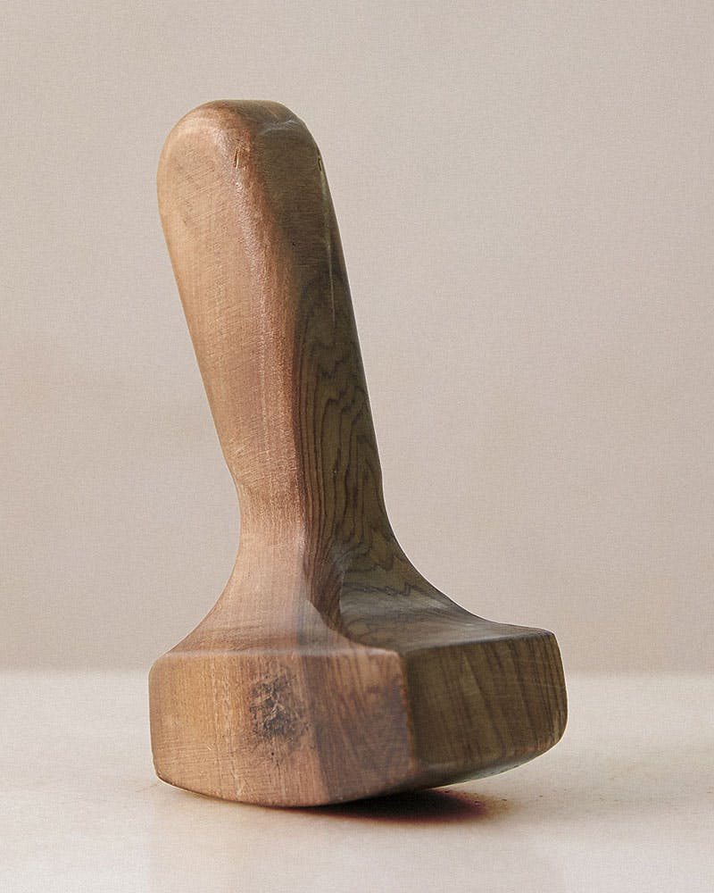 A wooden object sitting on top of a table