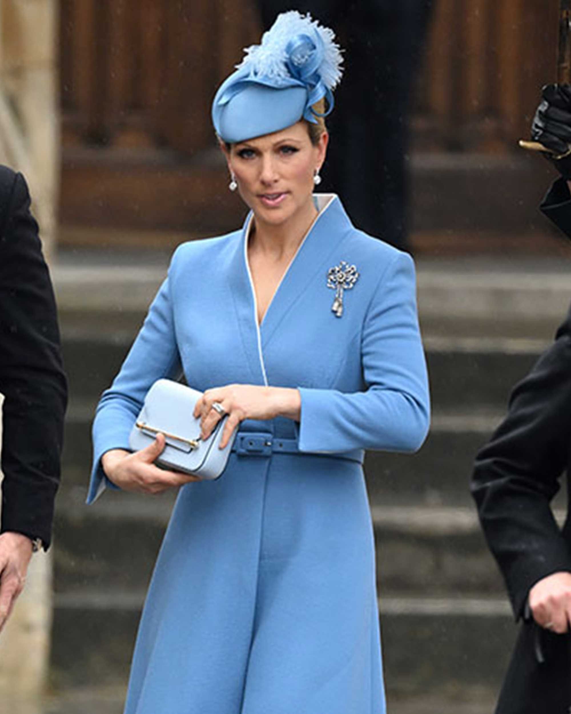 A woman in a blue coat and hat