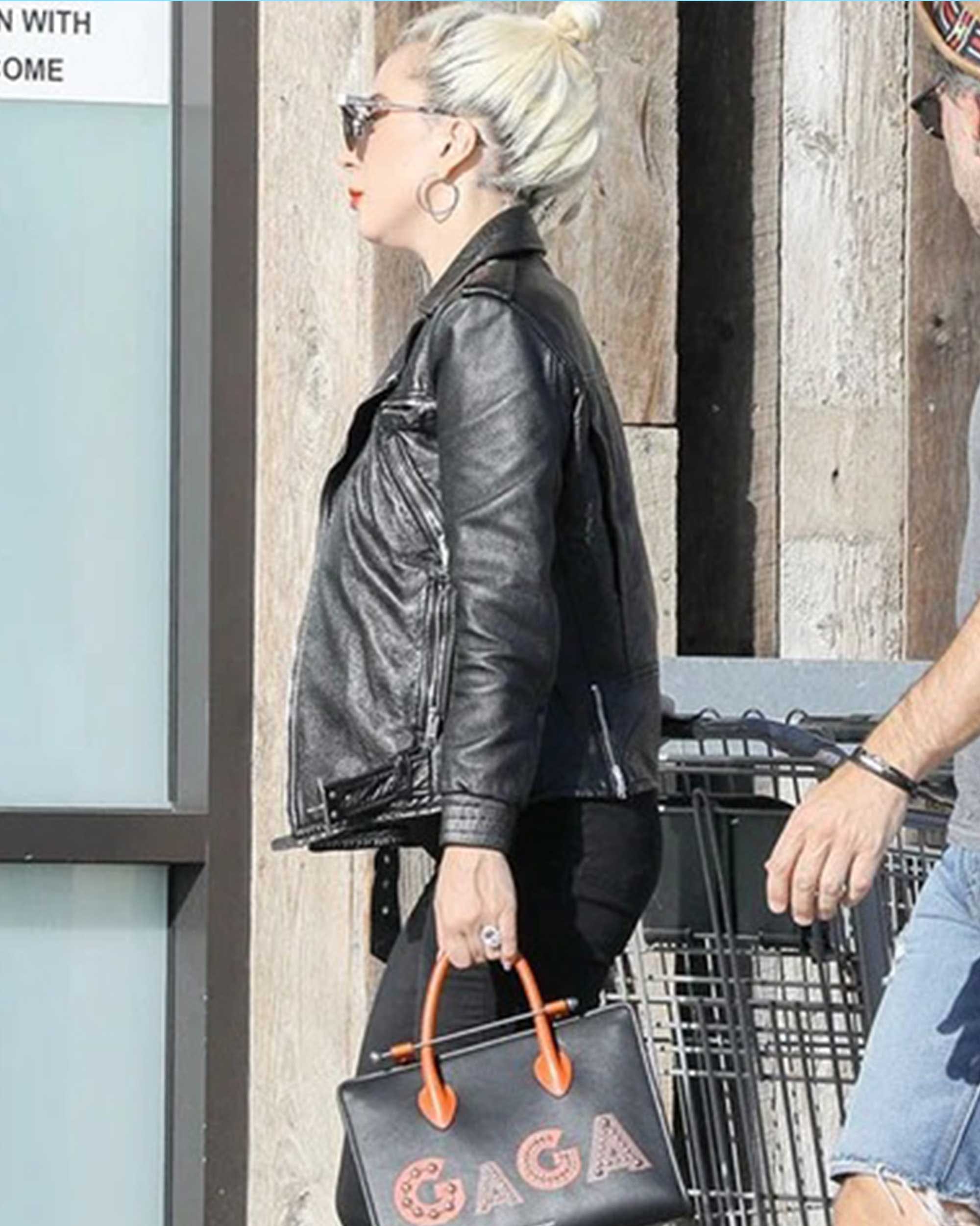 A man and a woman walking with a shopping cart