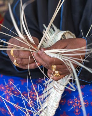 A woman holding a bunch of grass in her hands