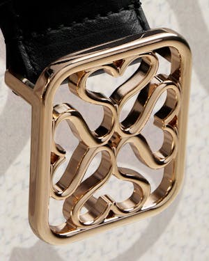 A close up of a watch on a white surface