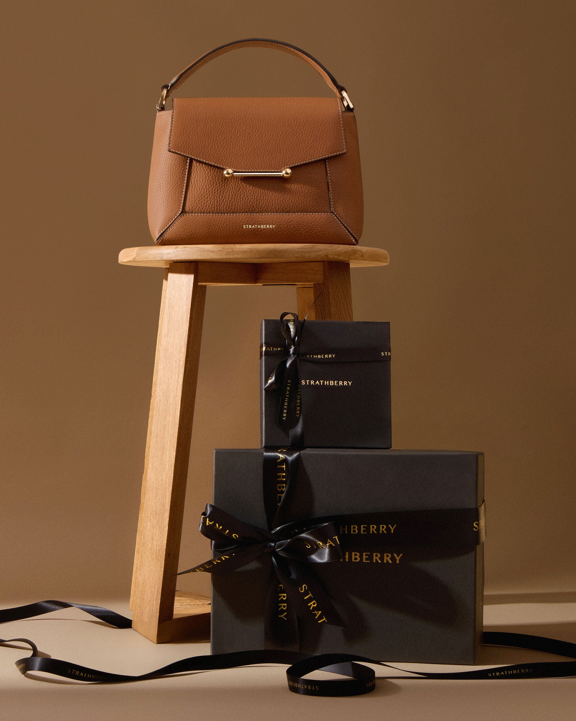 A brown purse sitting on top of a wooden stool