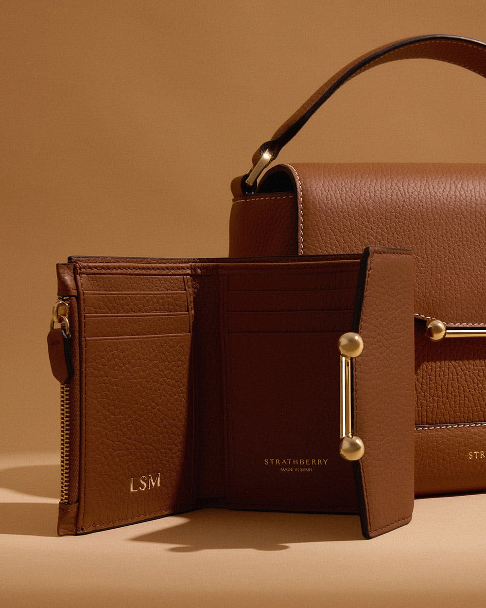 Two brown purses sitting next to each other