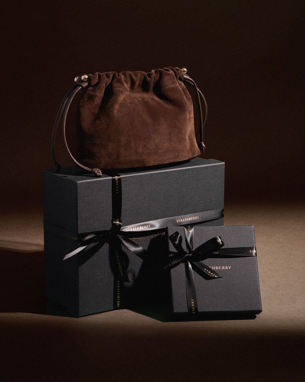 A brown bag sitting on top of two black boxes