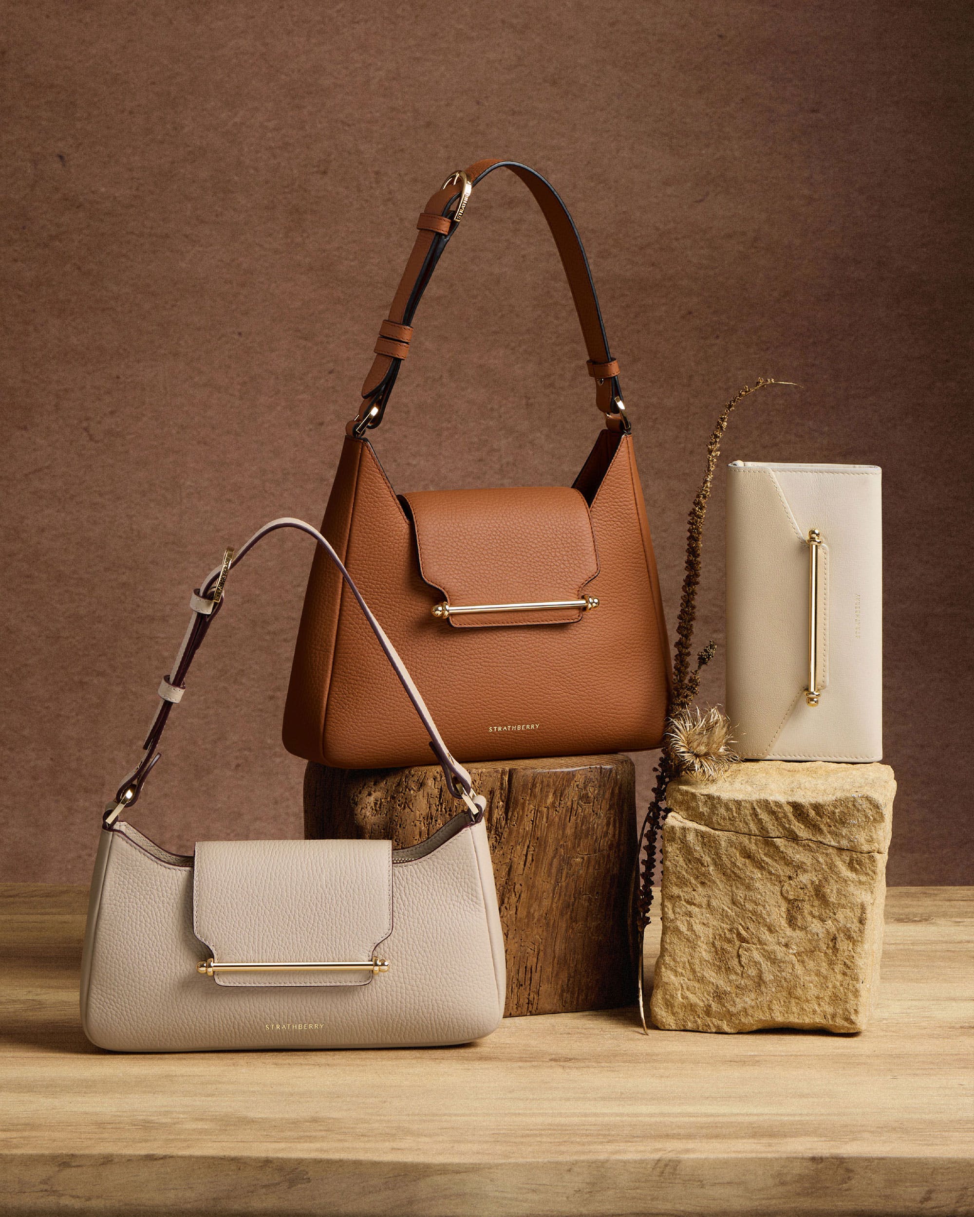 Three purses sitting on top of a wooden block