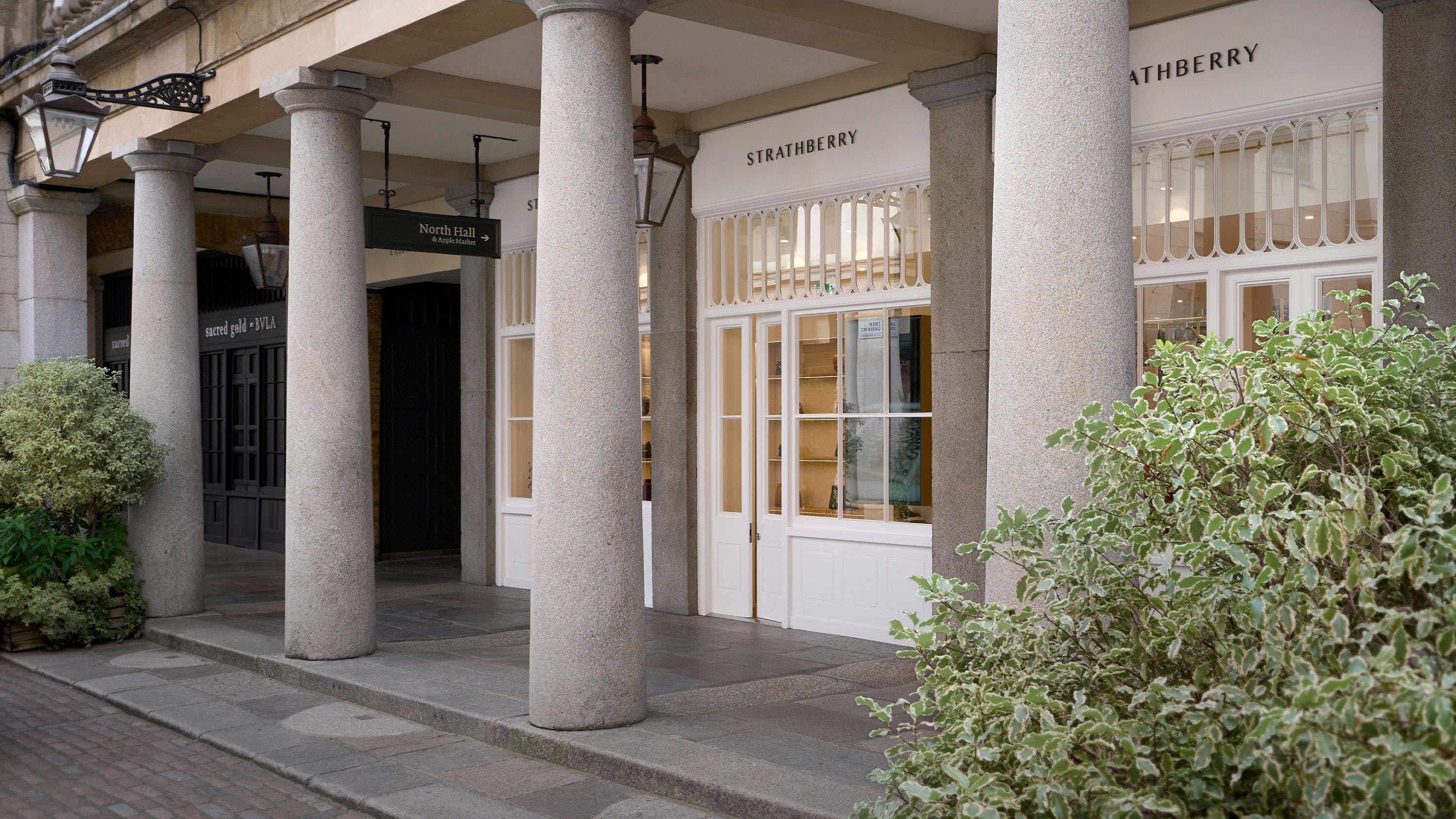 A building with columns and a clock on the front of it