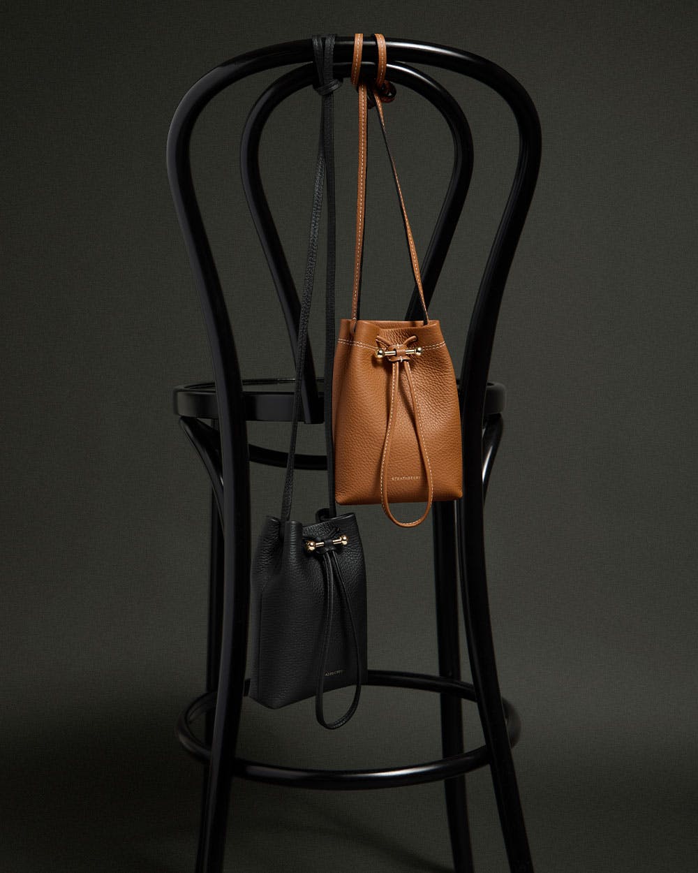 A brown and black bag sitting on top of a chair