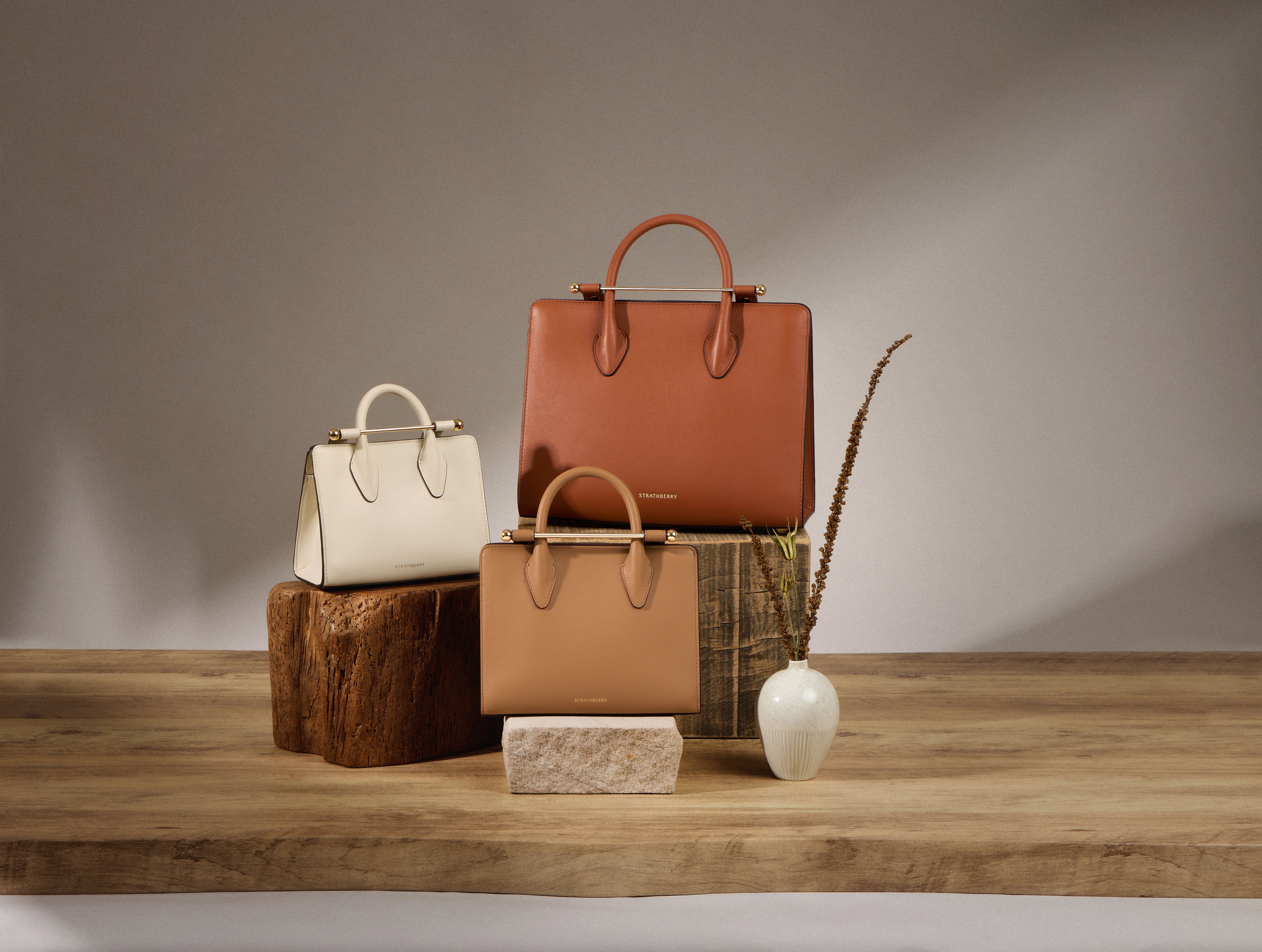 A group of purses sitting on top of a wooden table