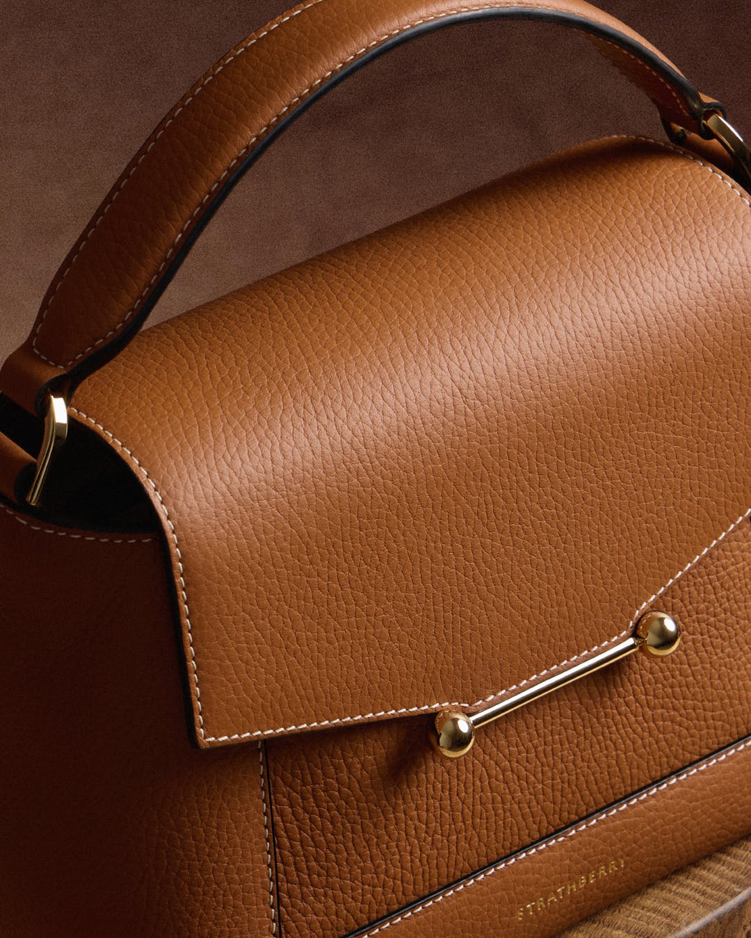 A brown purse sitting on top of a wooden table