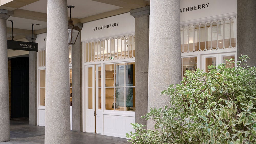 A building with columns and a clock on the front of it