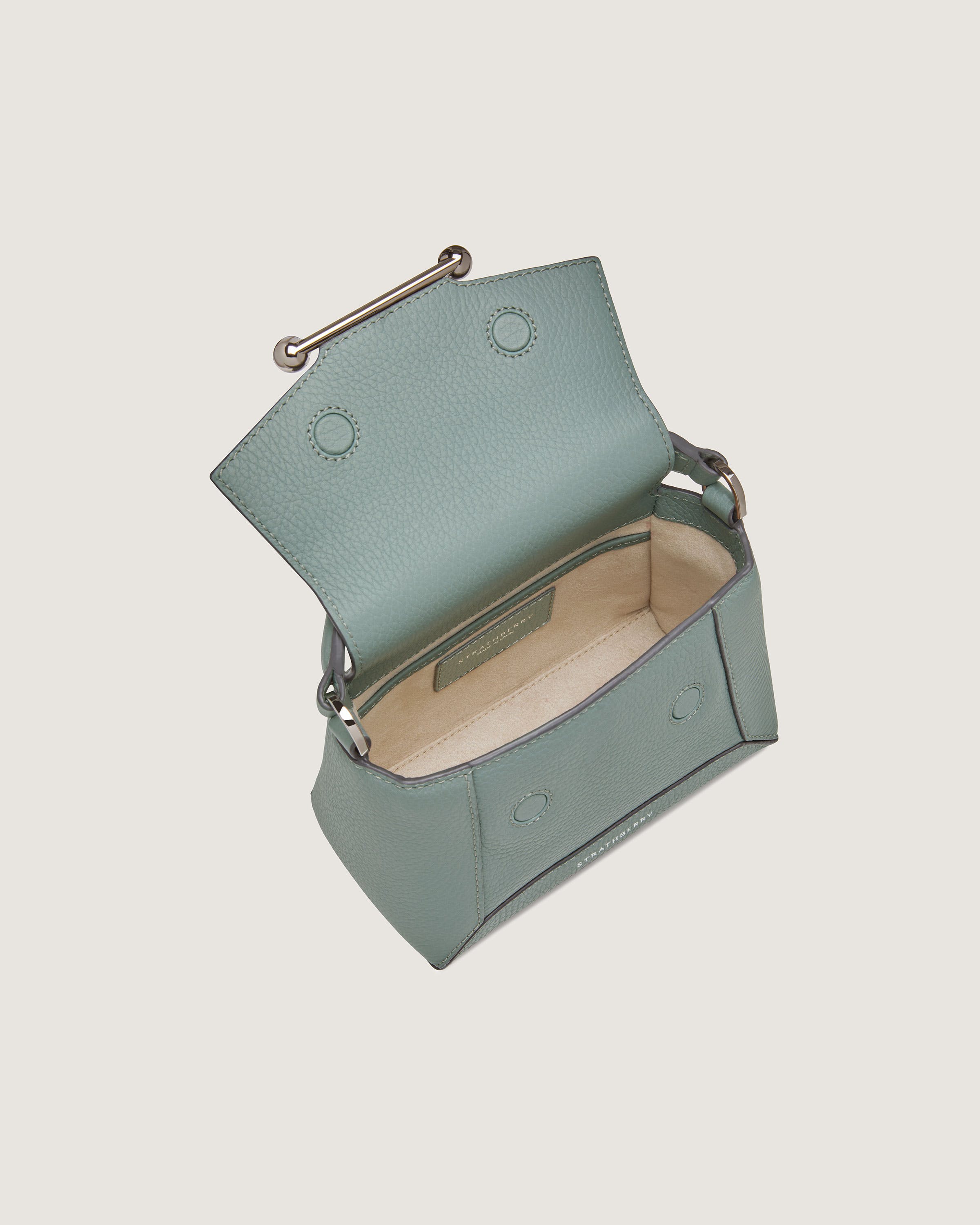 A small blue purse with a metal handle