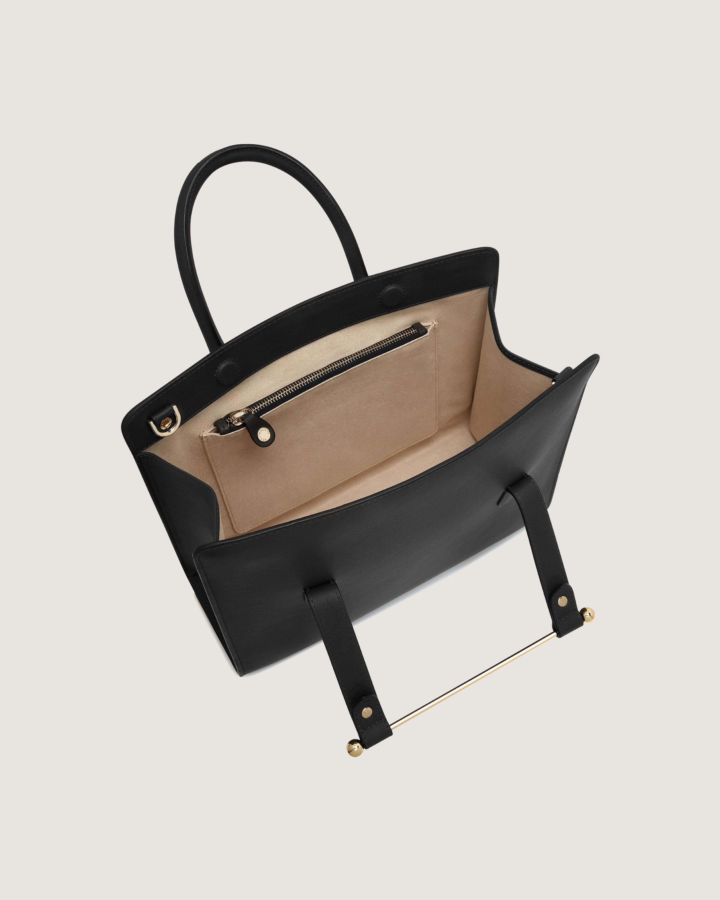 A black and beige handbag with a handle