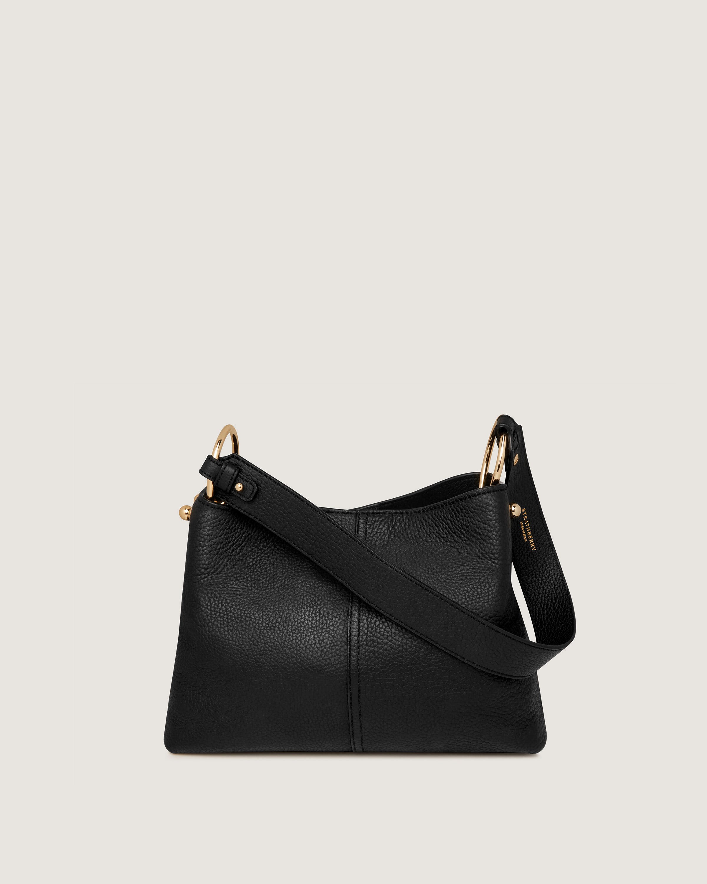 A black leather handbag with gold hardwares