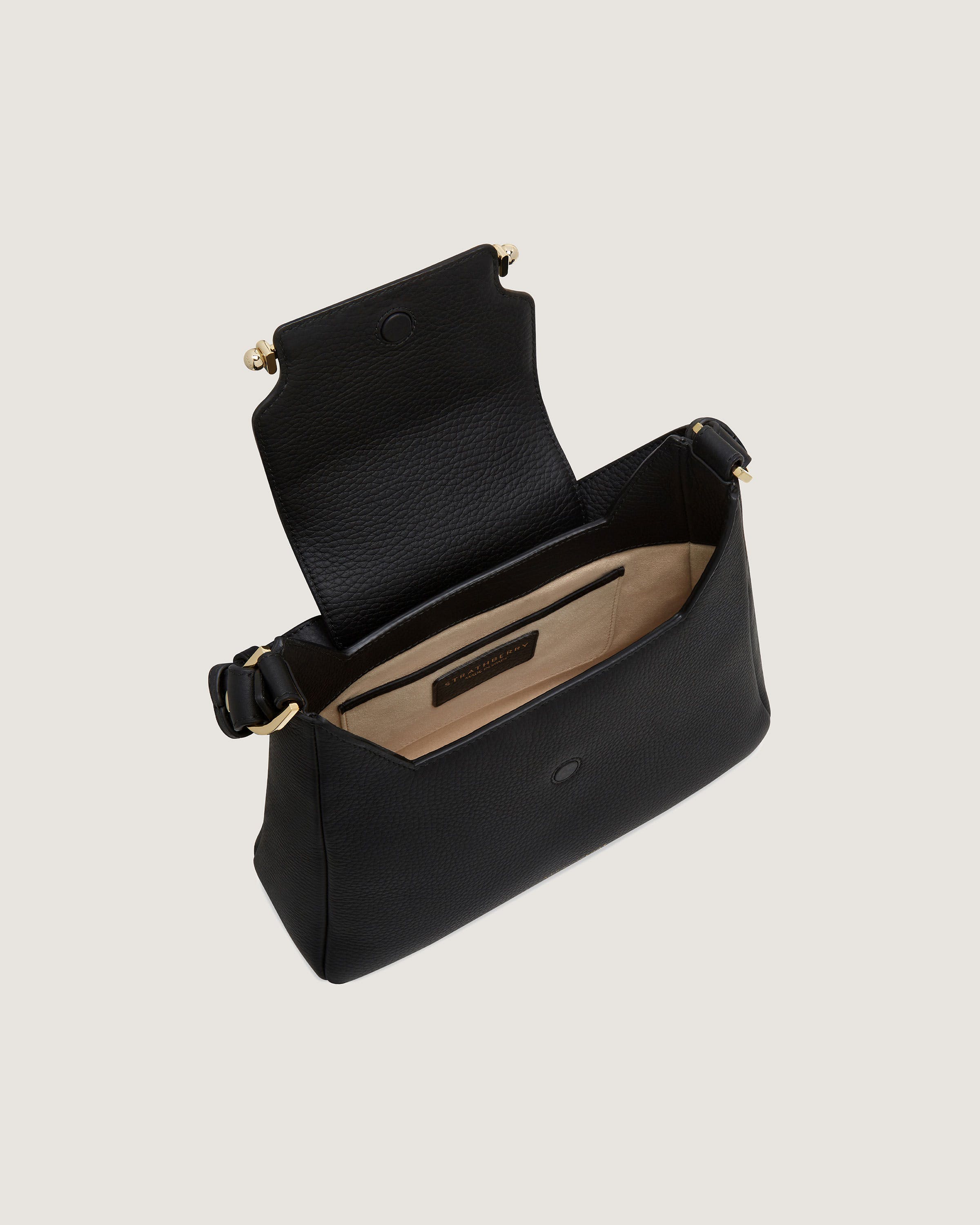 A black leather purse with a gold clasp