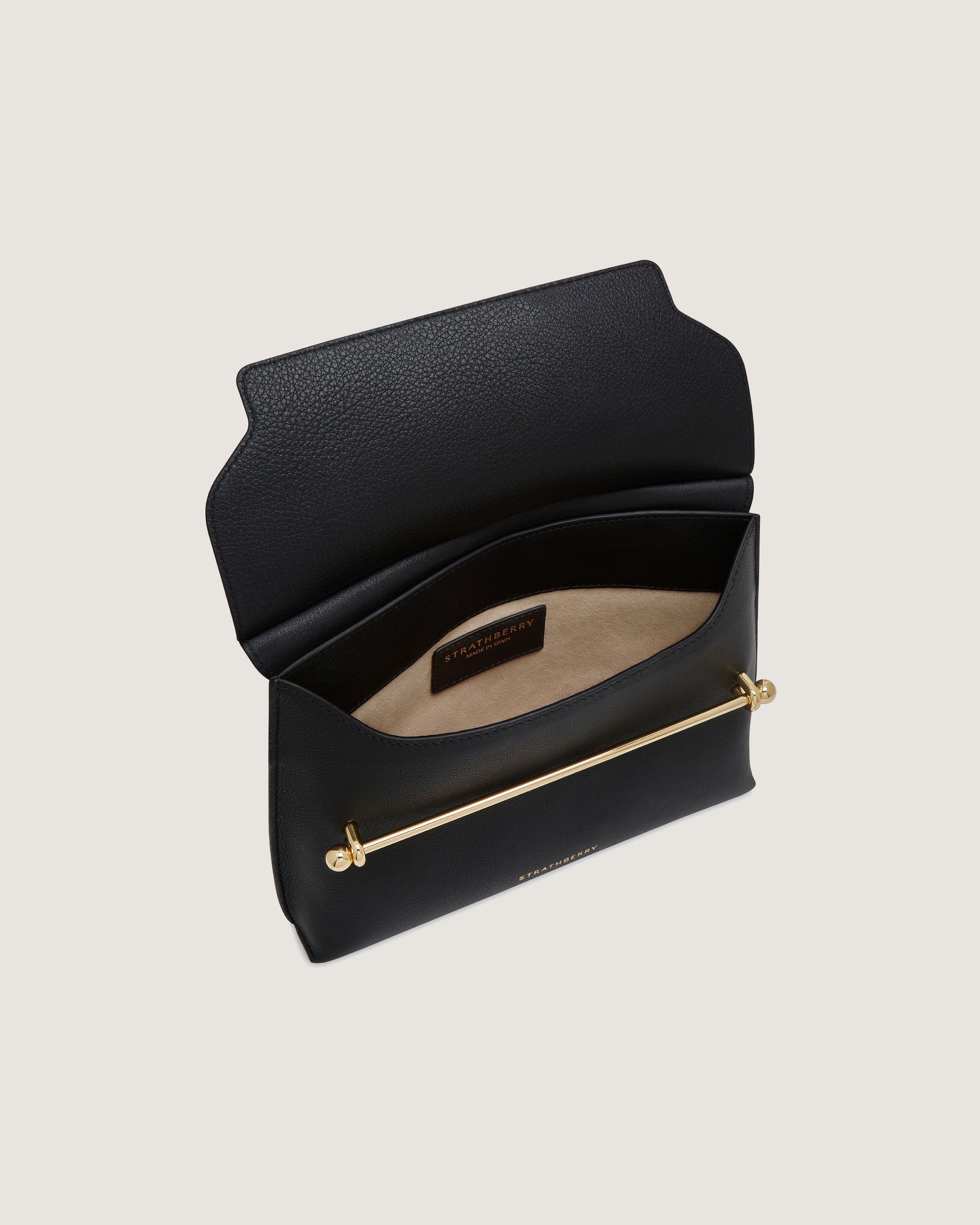 A black purse with a gold handle