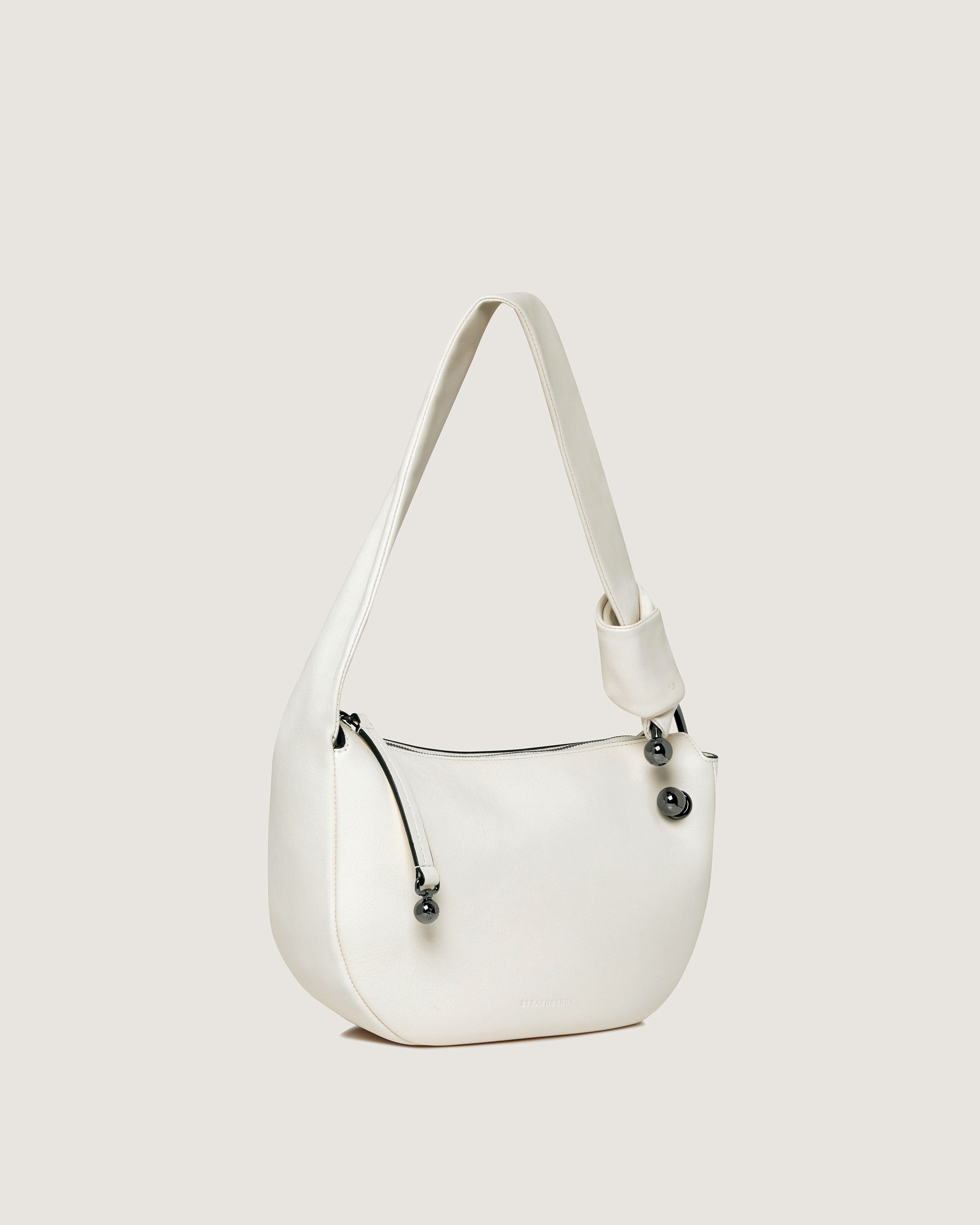 A white purse with a zipper on the side