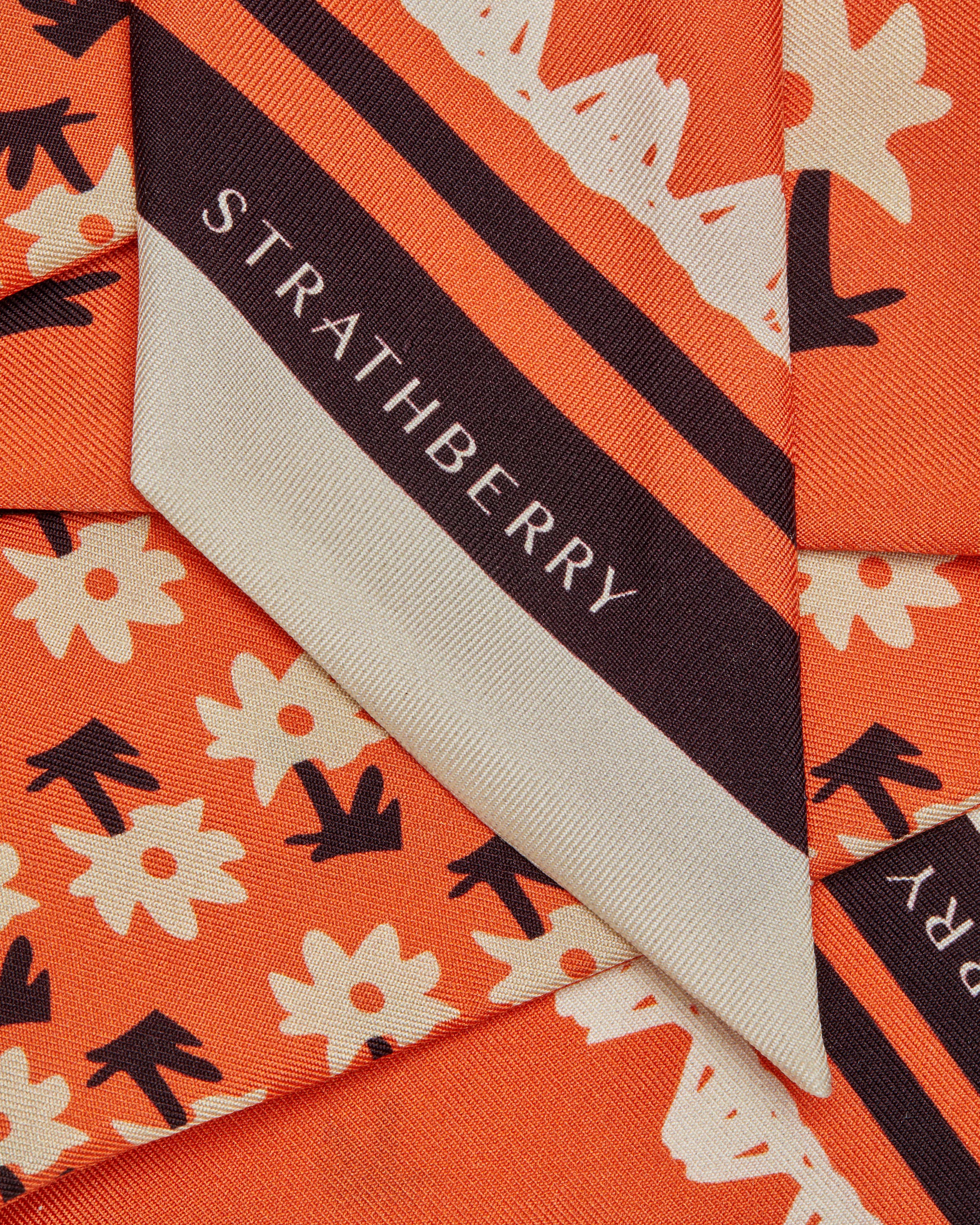 A close up of a tie with a name tag on it