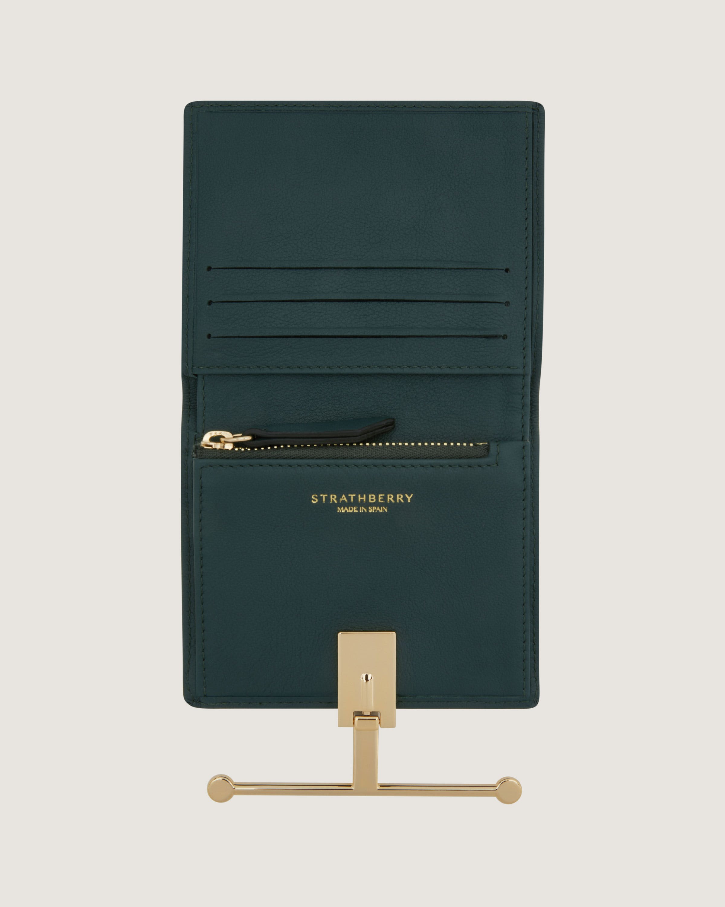 A green card holder with a gold handle