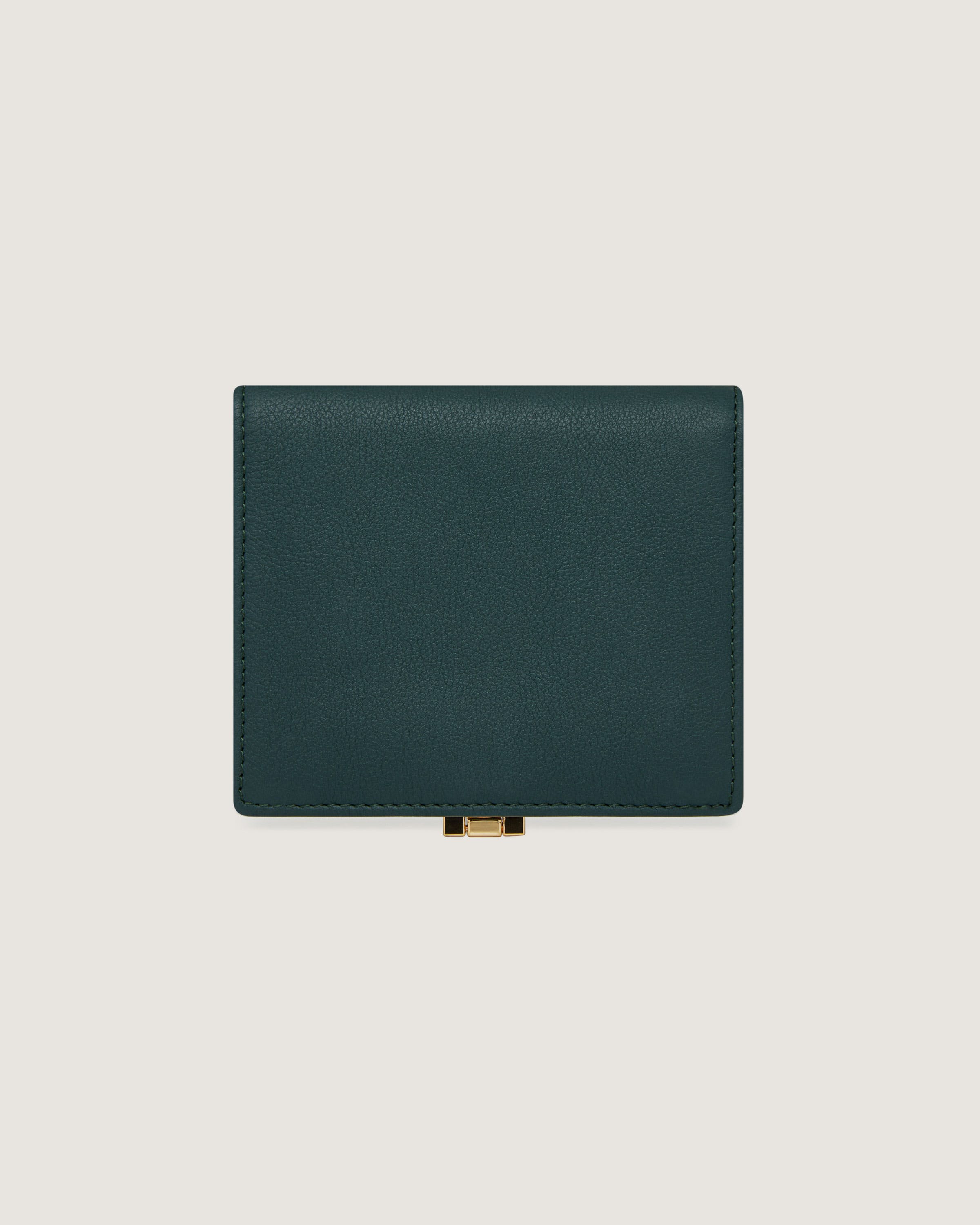 A green leather wallet on a white background