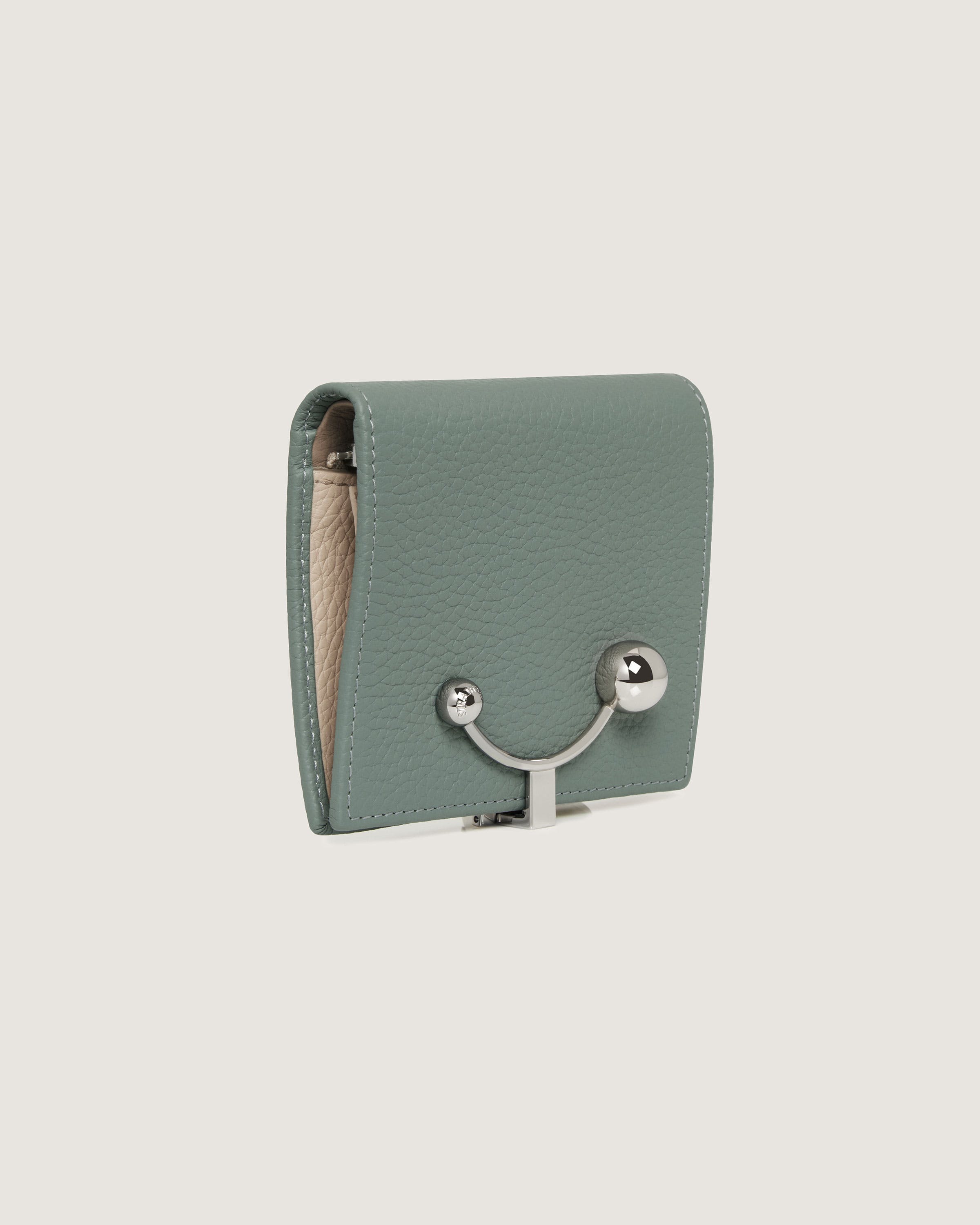 A small green purse with a metal handle