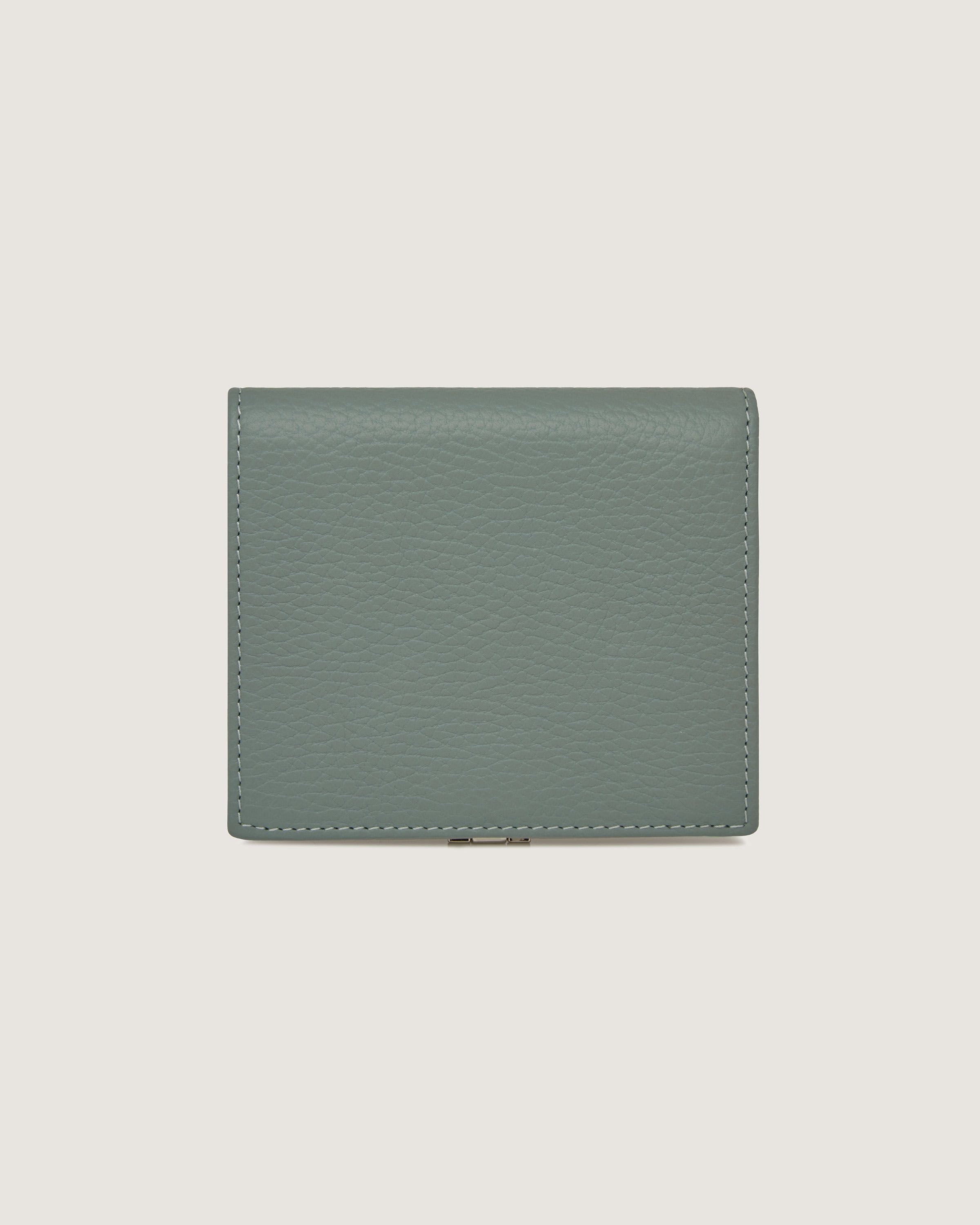 A green leather wallet on a white background