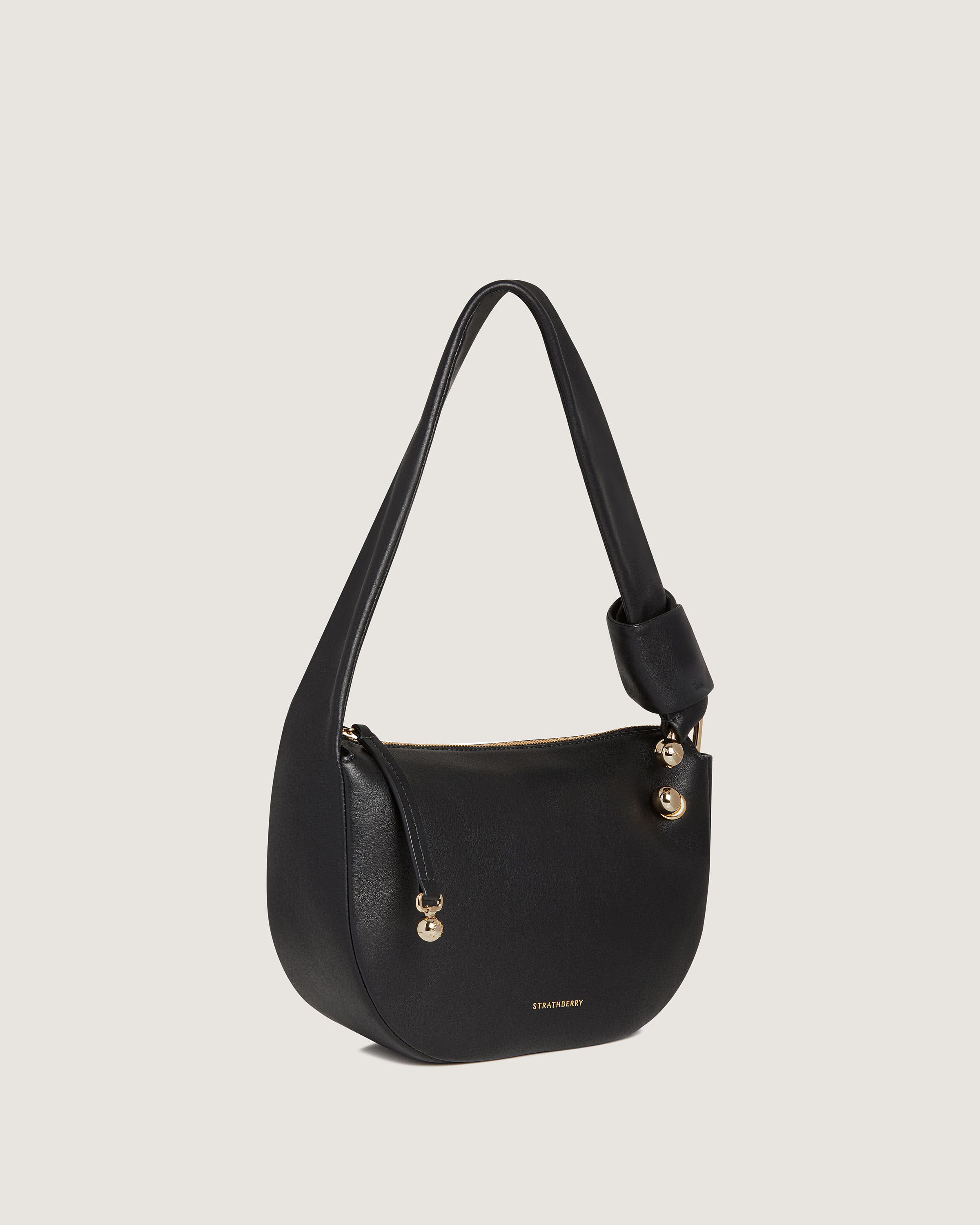 A black leather shoulder bag with gold hardwares