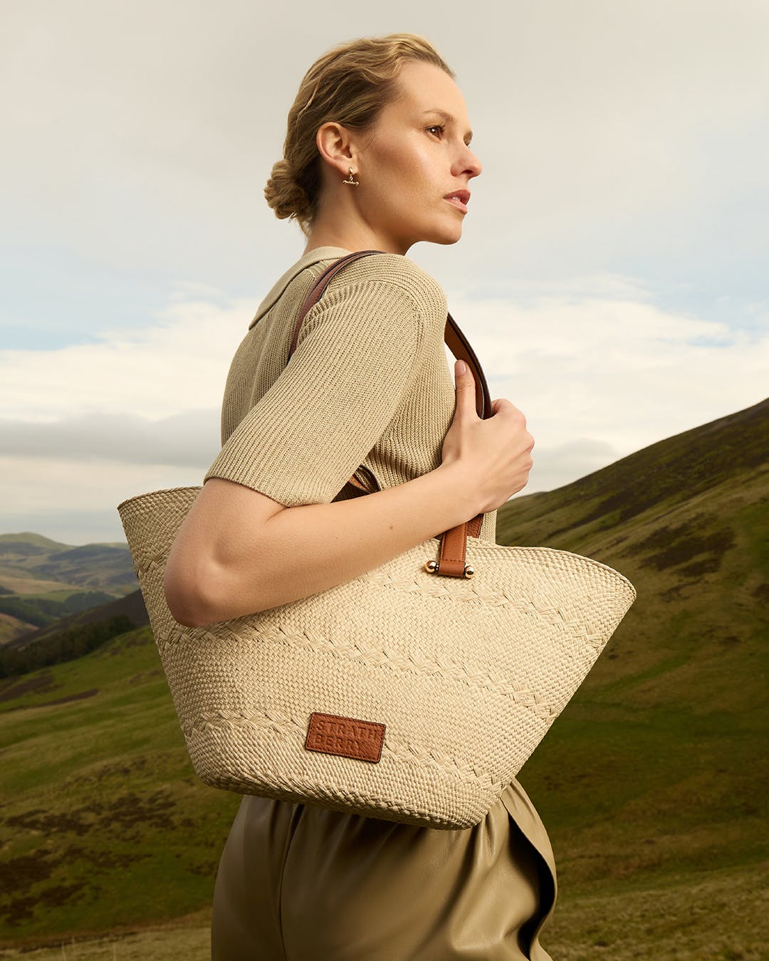 A woman is carrying a large woven bag