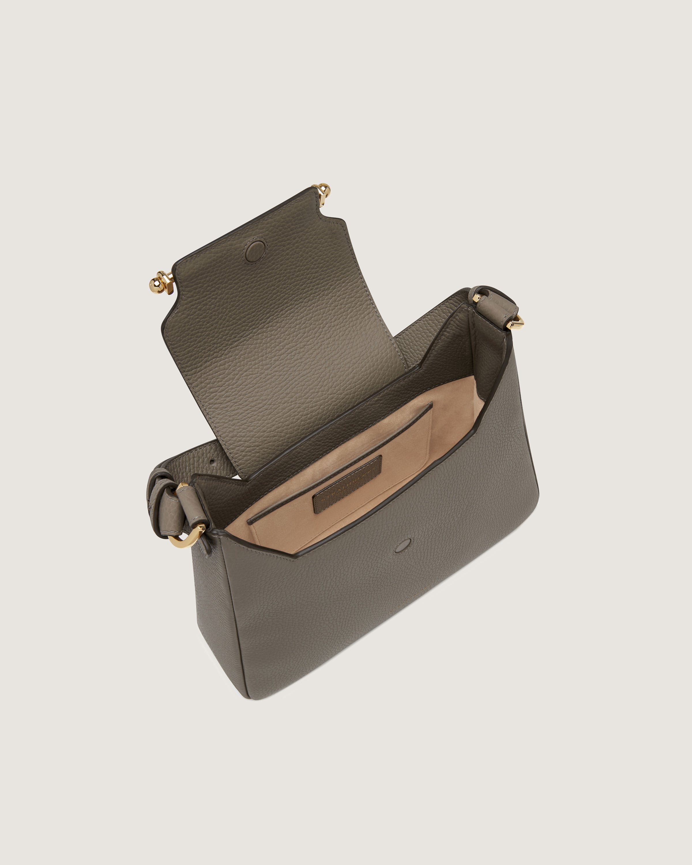 A grey purse with a brown handle