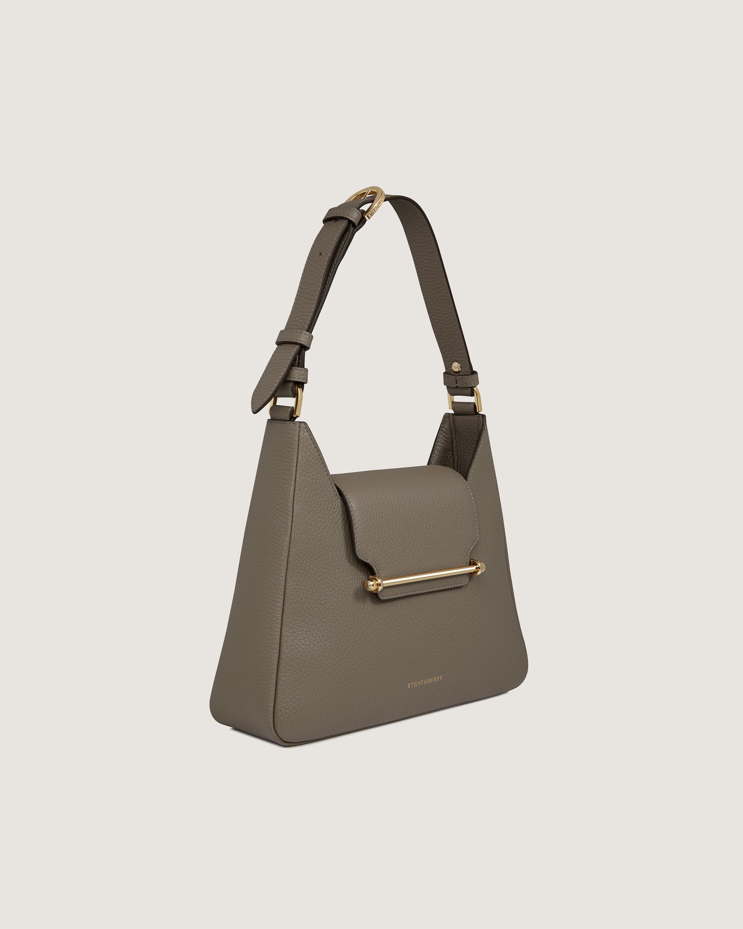 A grey handbag with a gold handle