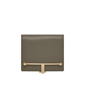 A brown wallet with a gold bar on the front