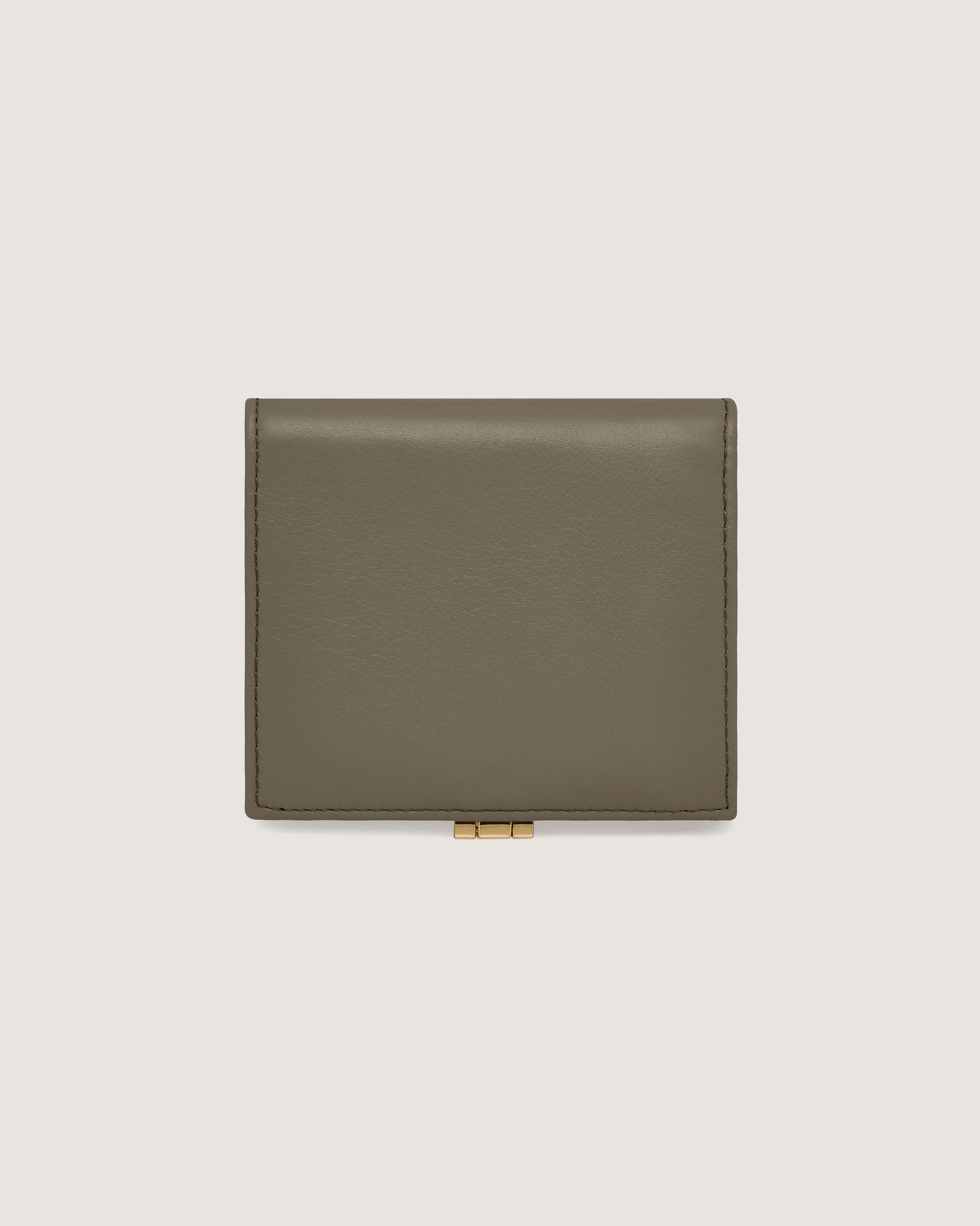 A grey leather wallet on a white background