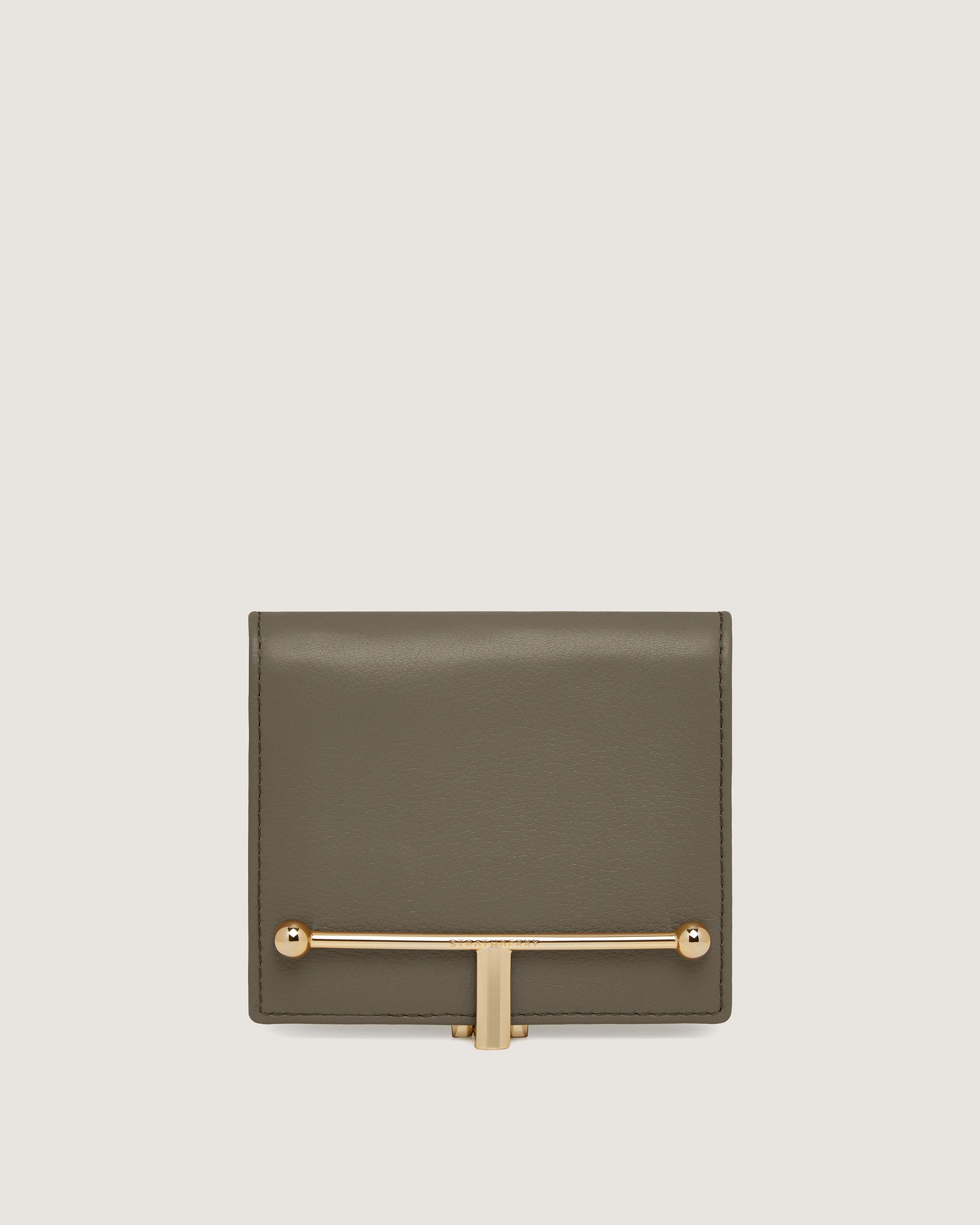 A grey leather wallet with a gold bar on the front