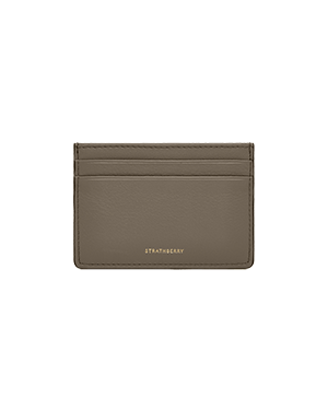 A brown card case on a green background