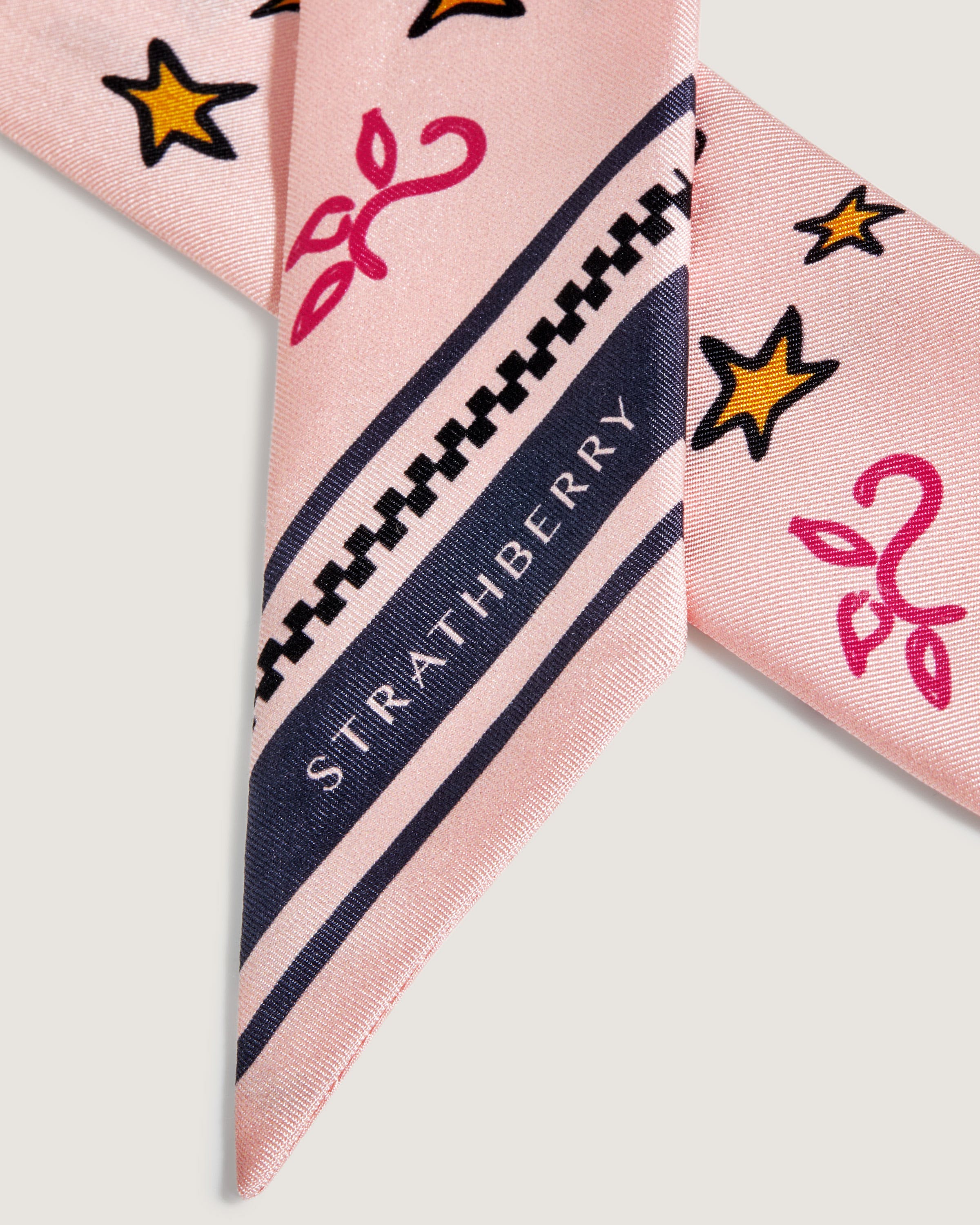 A pink tie with stars and stripes on it