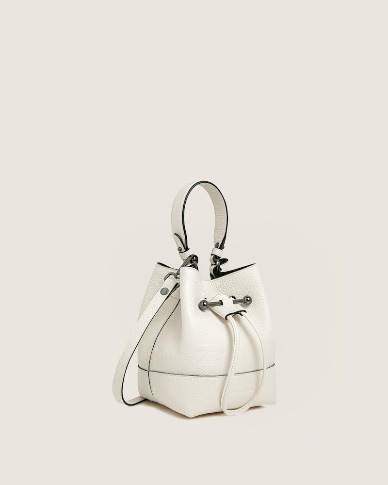 A white handbag with a black handle