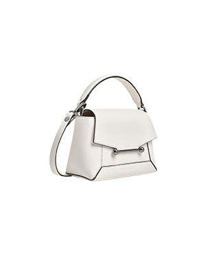 A white handbag on a green background