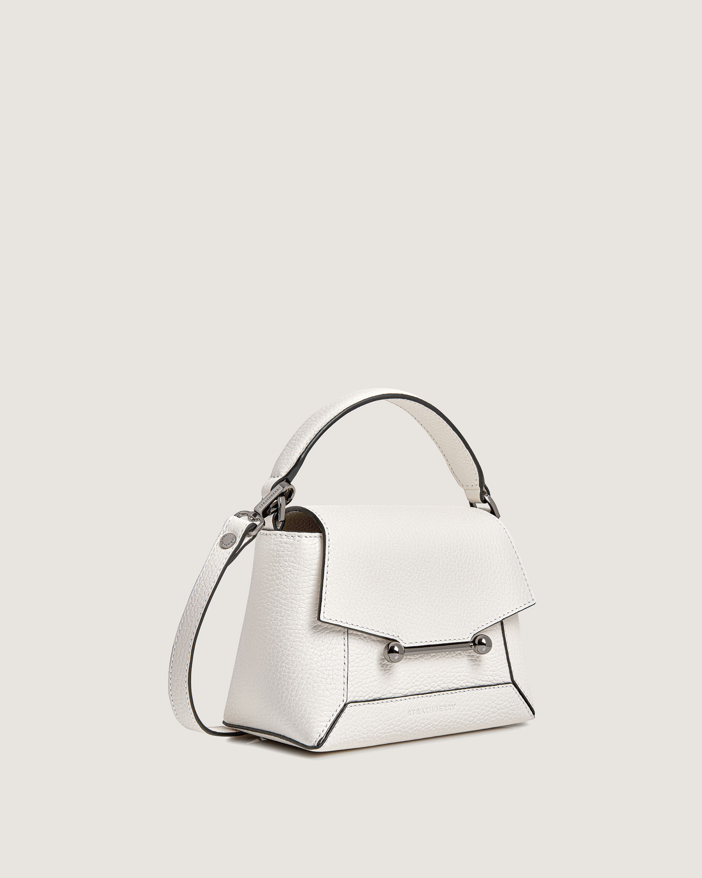 A white handbag with a long strap