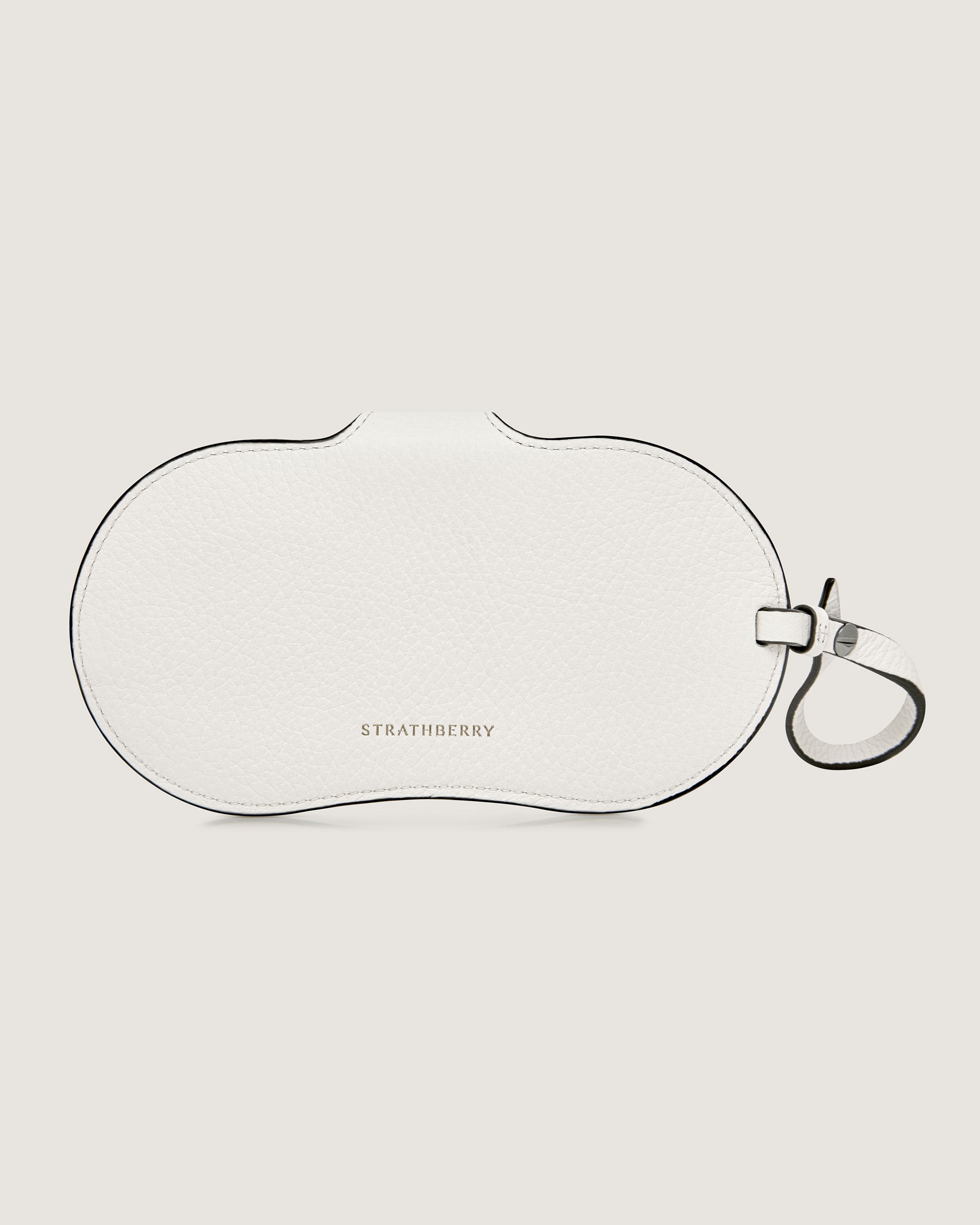 A white purse with a black strap