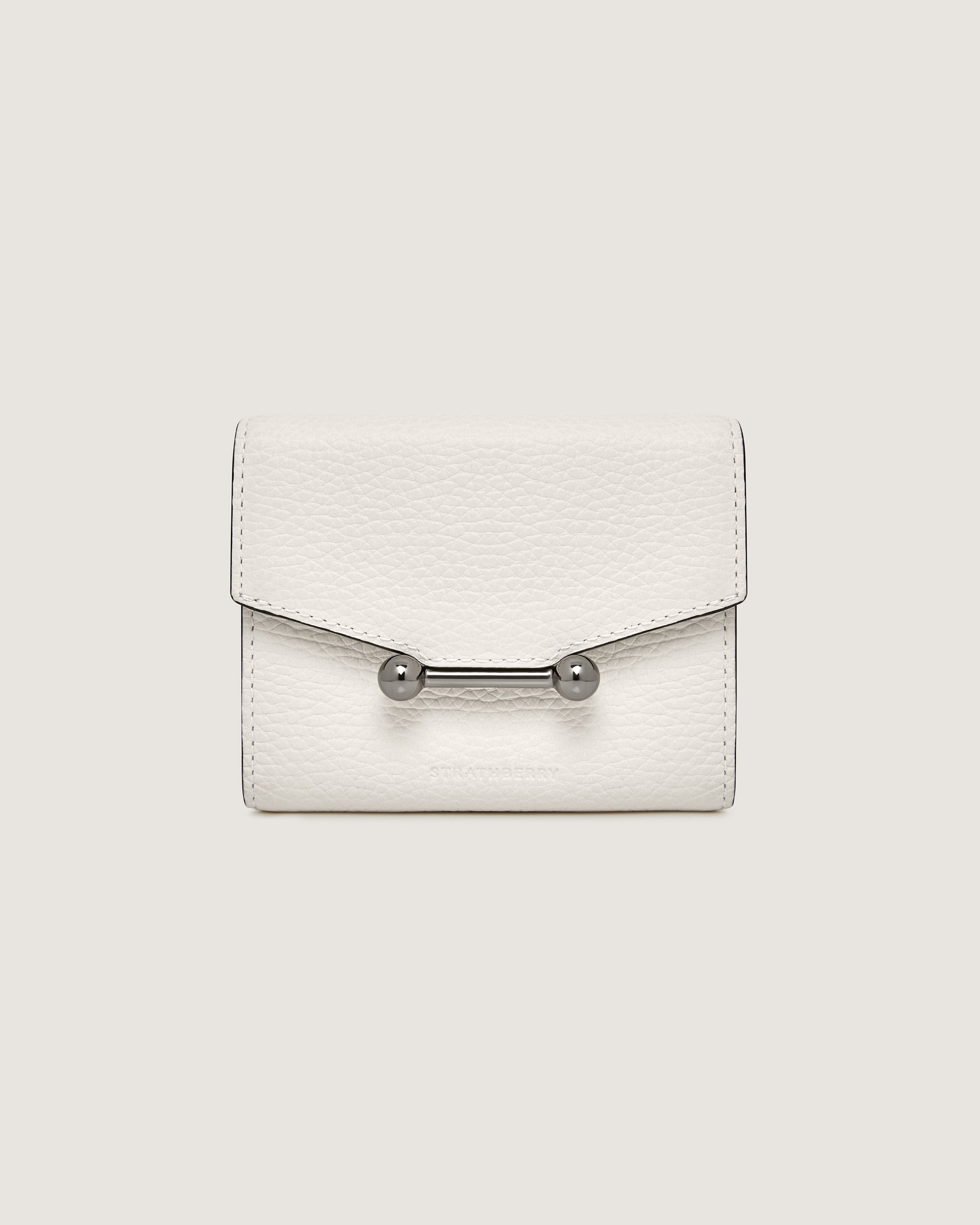 A white purse with a metal handle