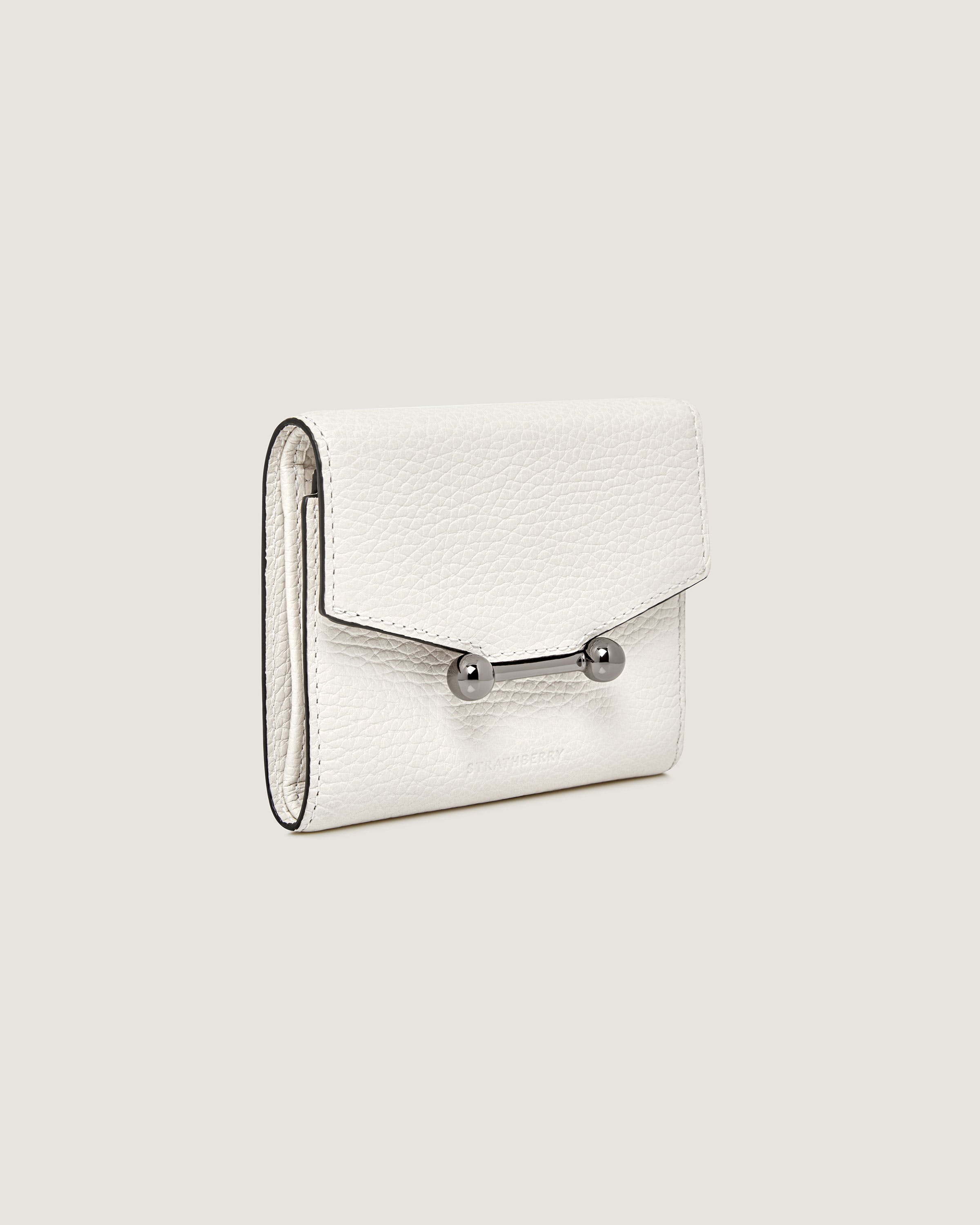 A white purse with a metal handle on a white background