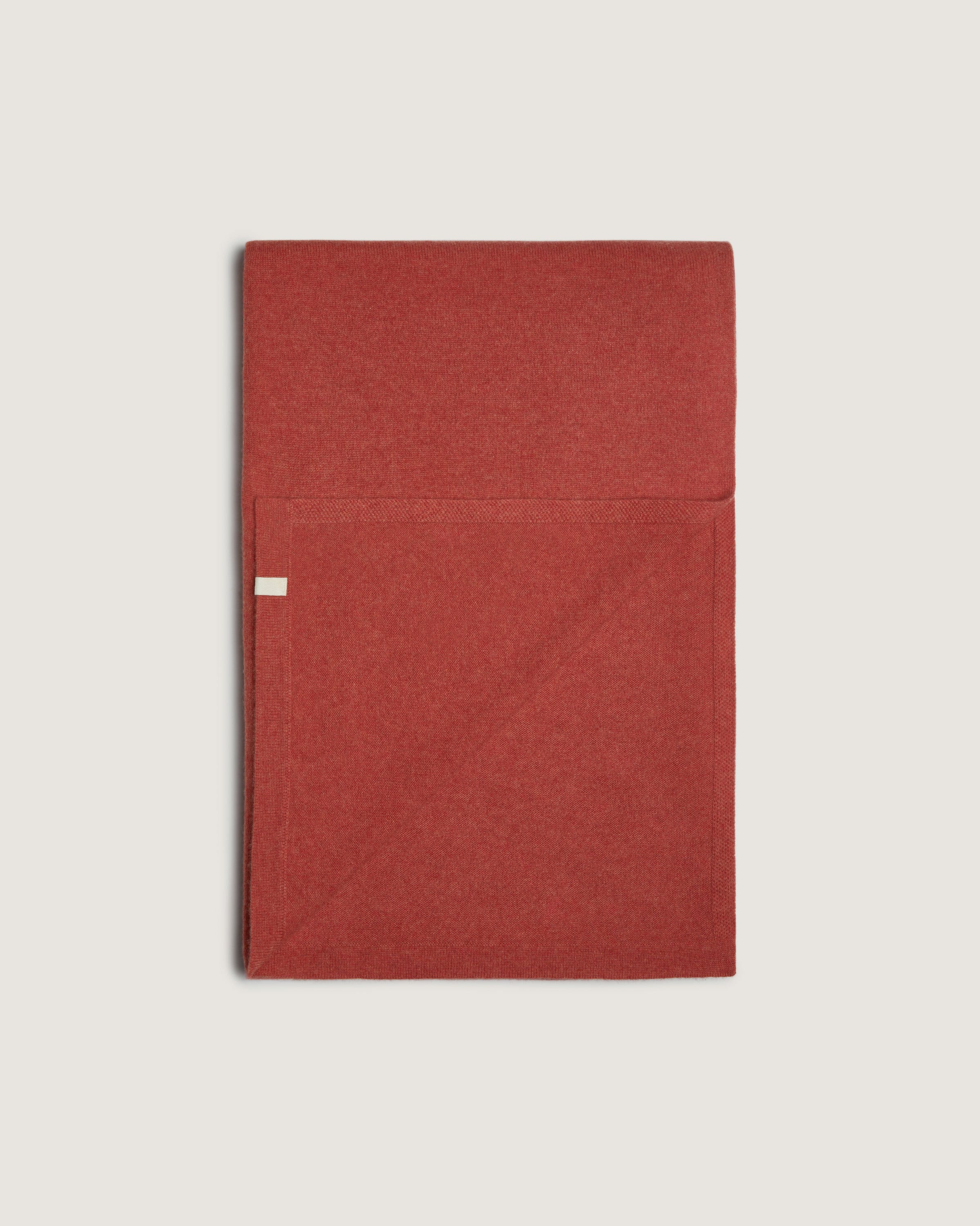 A folded red cloth on a white background