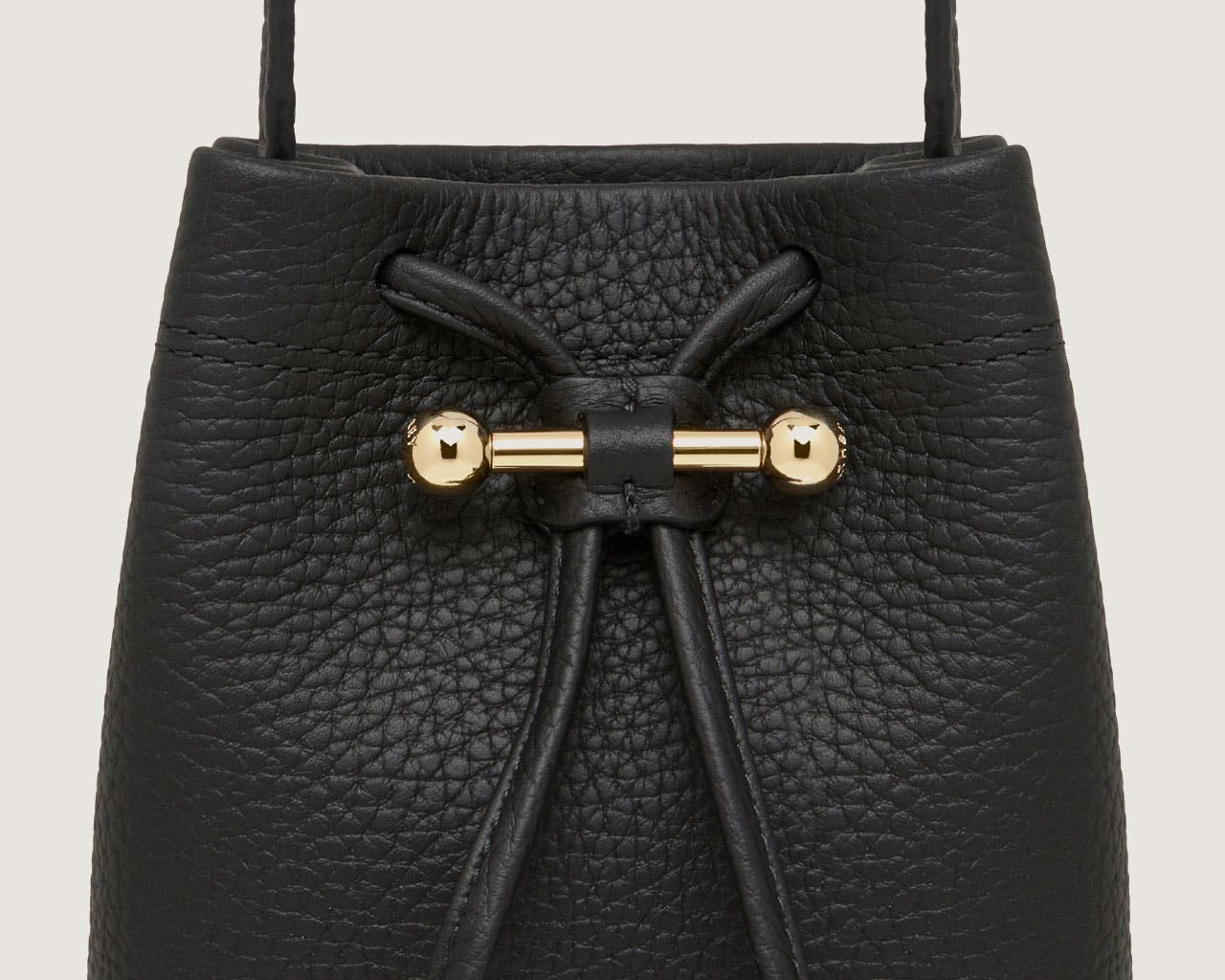 A black handbag with a gold handle