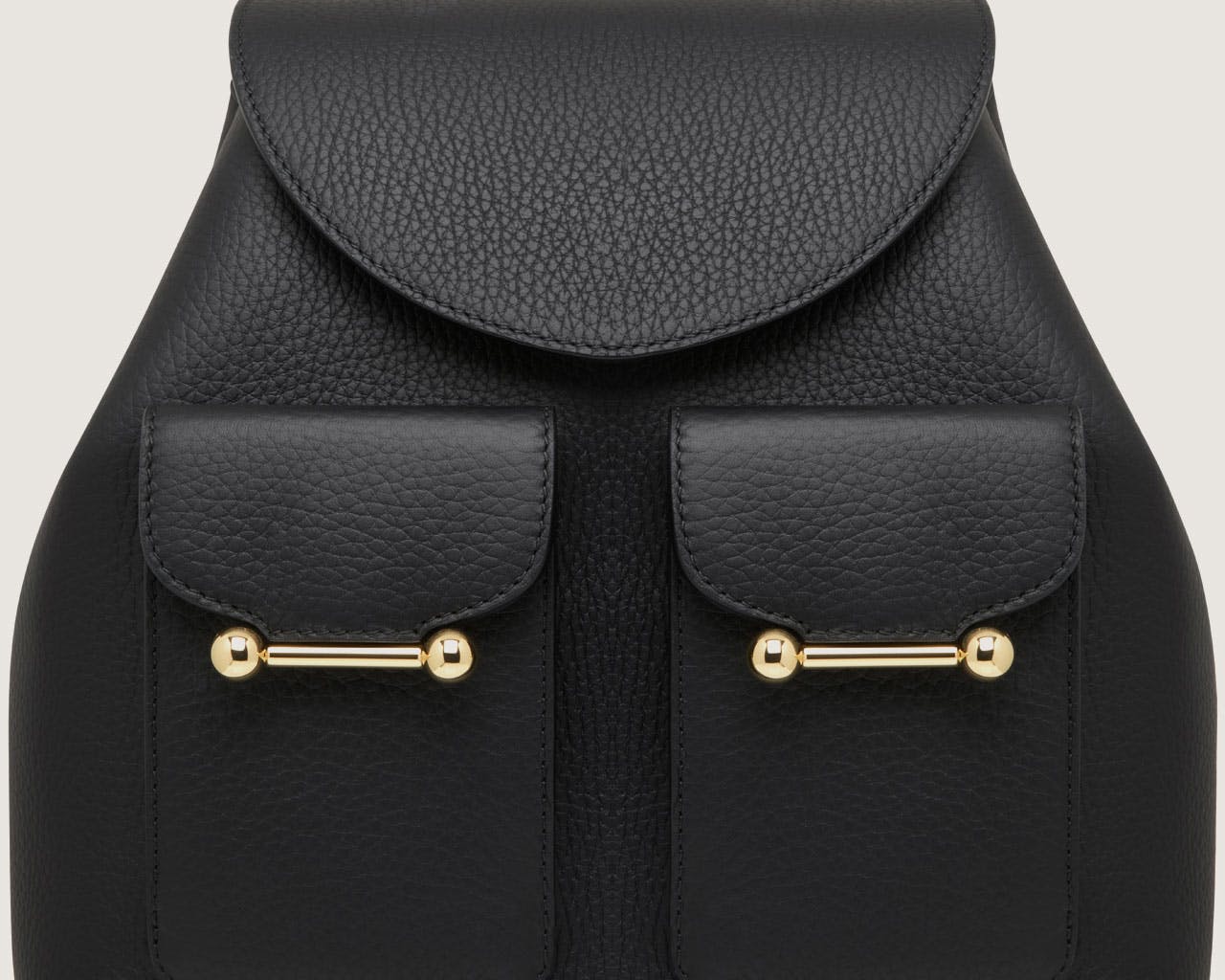 A black leather backpack with gold hardwares