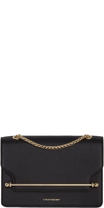 A black clutch bag with a gold chain