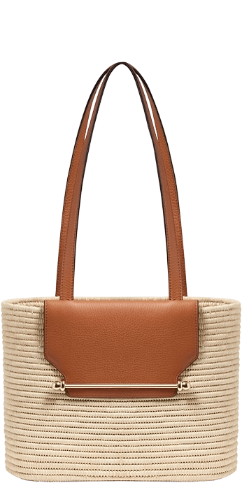 A straw bag with a tan leather handle