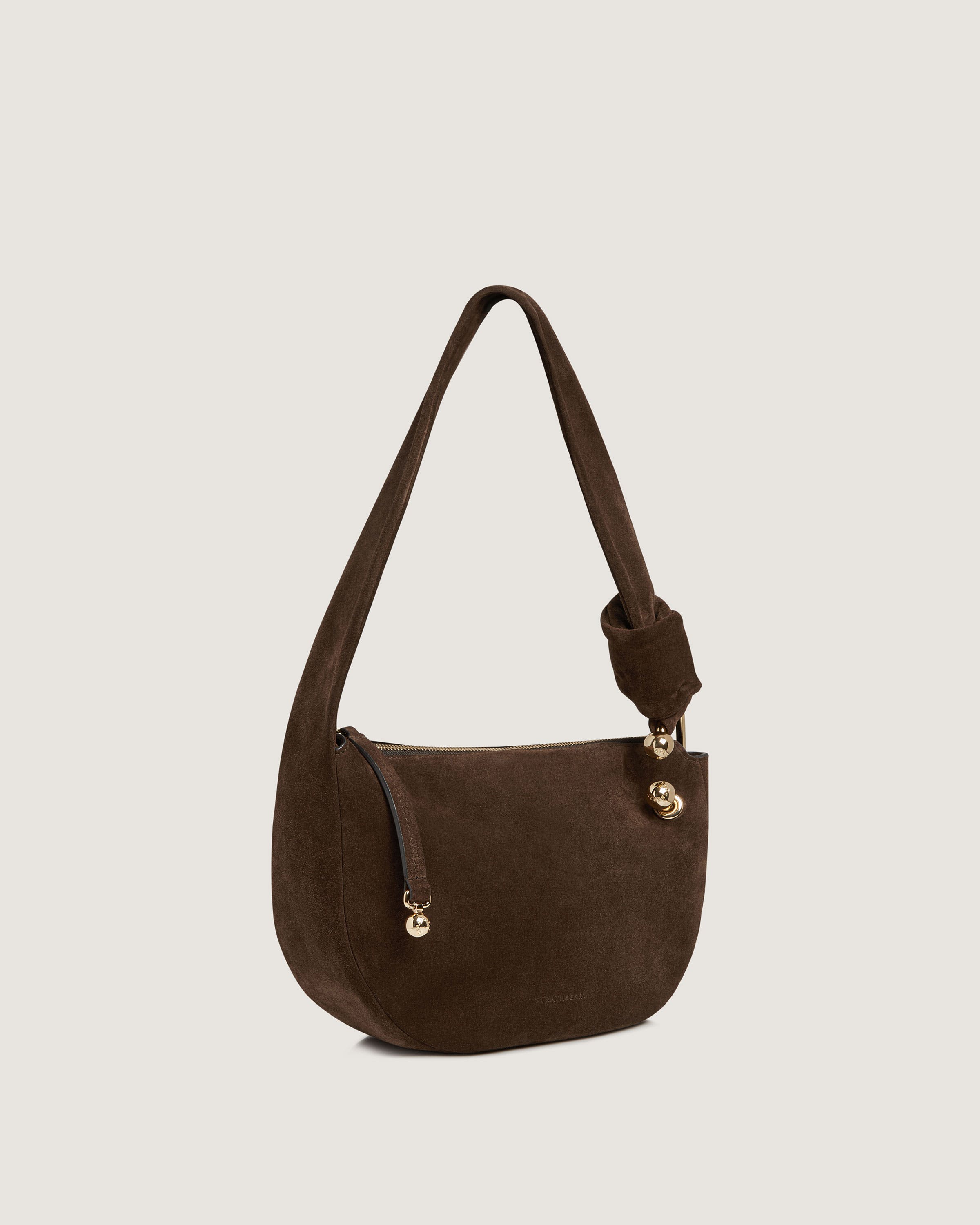 A brown purse with a handle on it