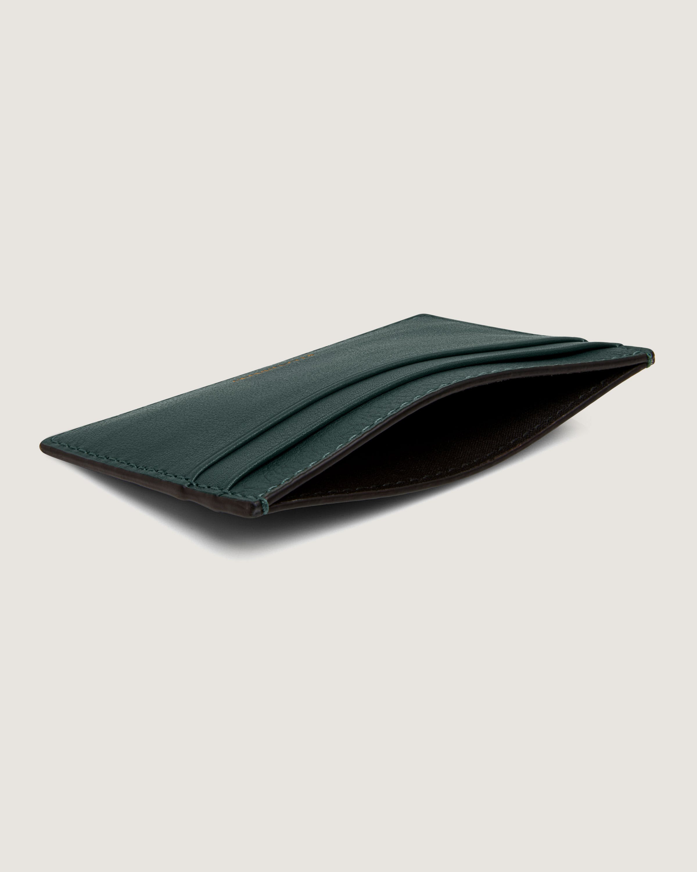 A green leather wallet on a white background